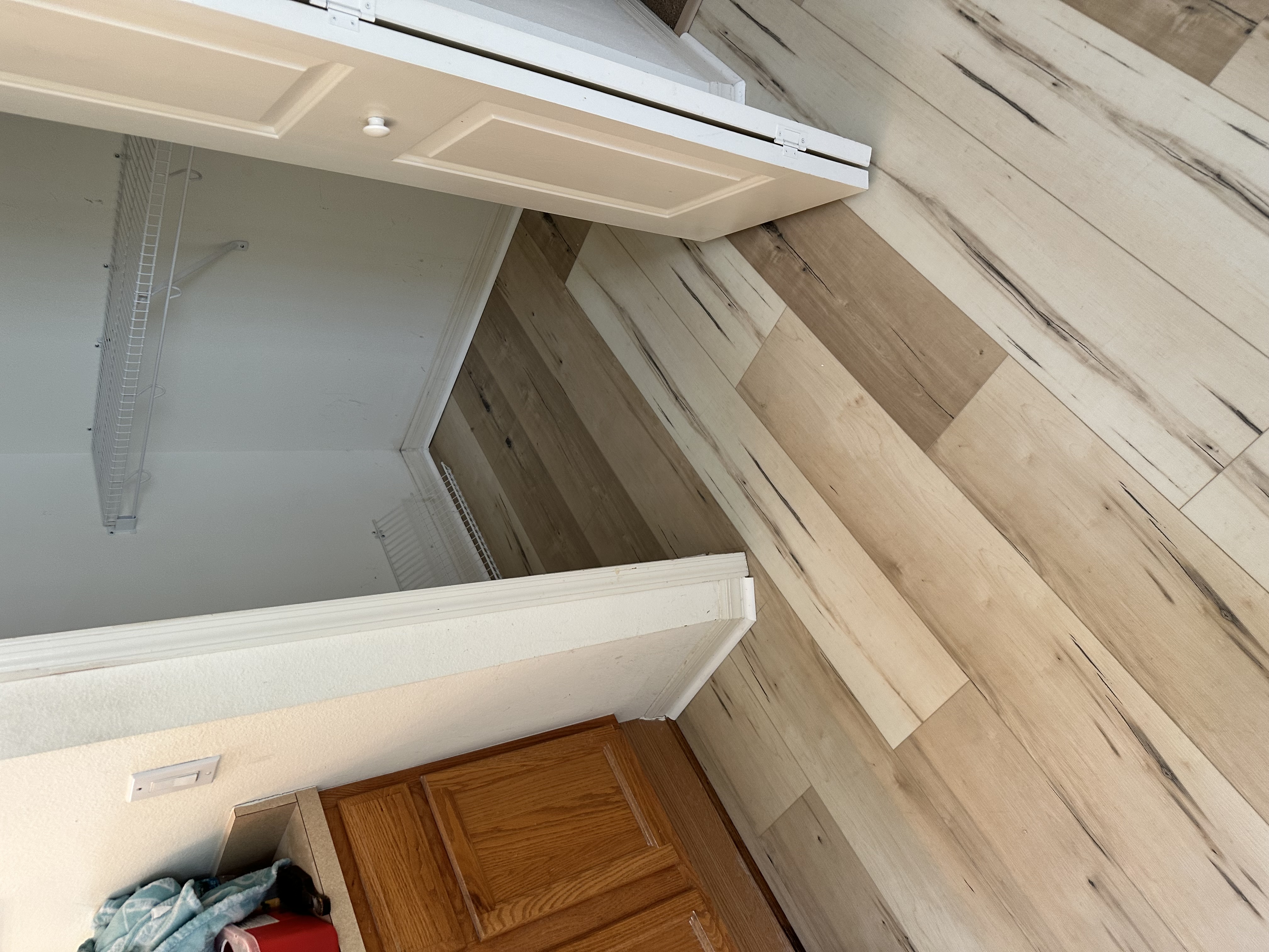 Closet threshold in a Tampa, FL home with new whitewashed plank flooring