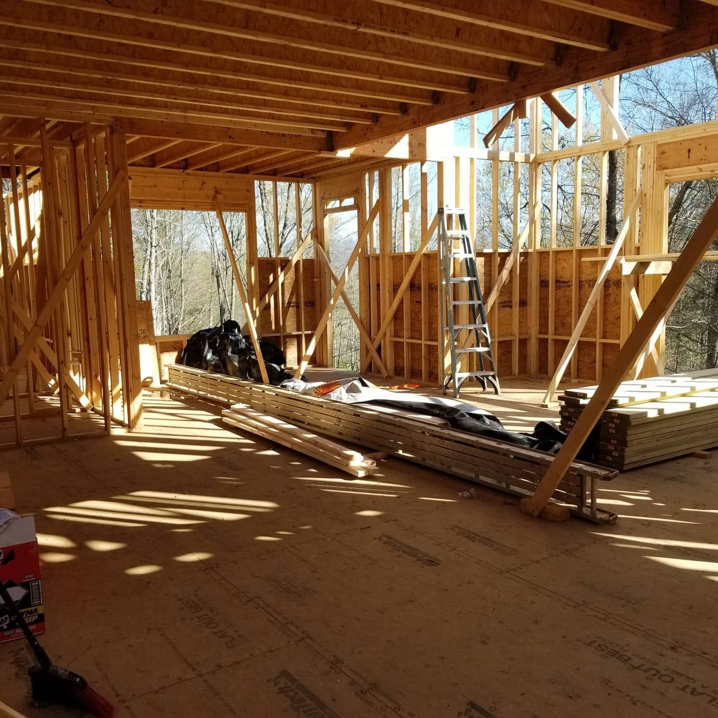 Riverstone custom home under construction with mountain views through the framing