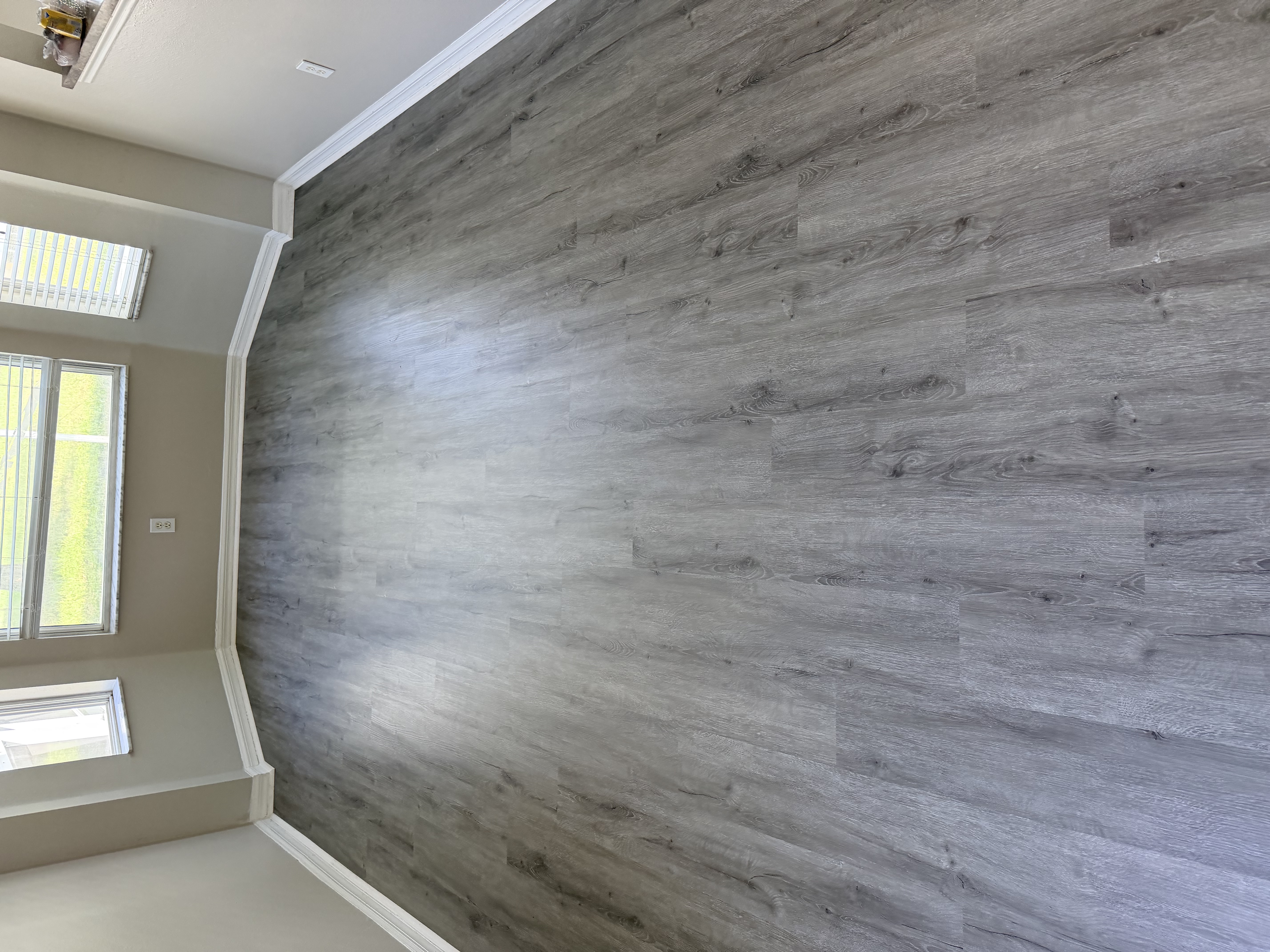 Tampa, FL bay window room with new grey plank flooring