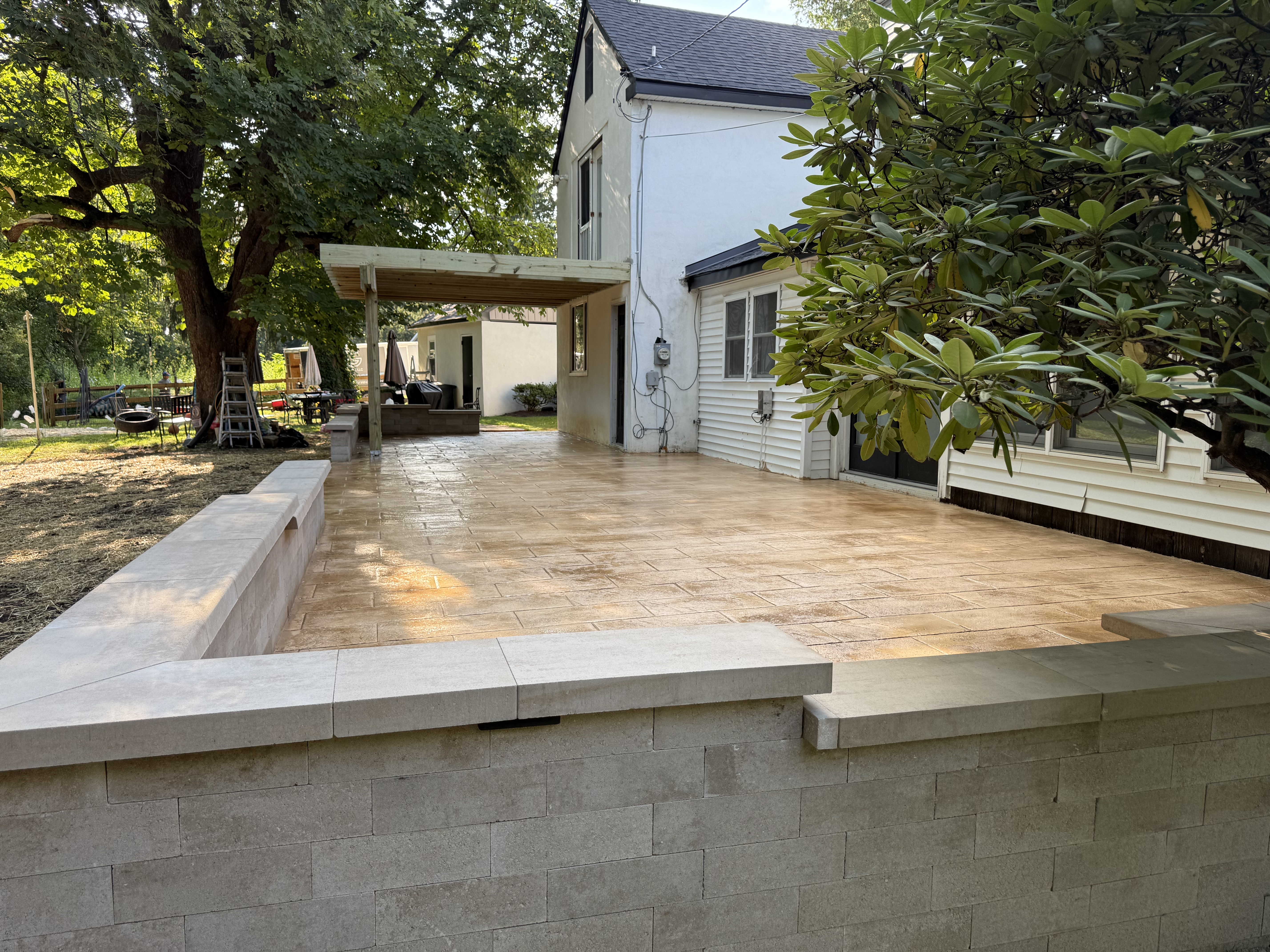 AWG Builds paver patio with block seat walls and pergola