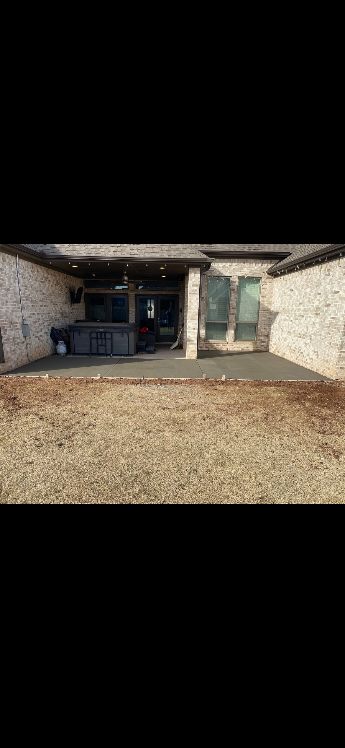 Concrete patch poured at an entry doorway threshold by Rock of Ages Concrete LLC