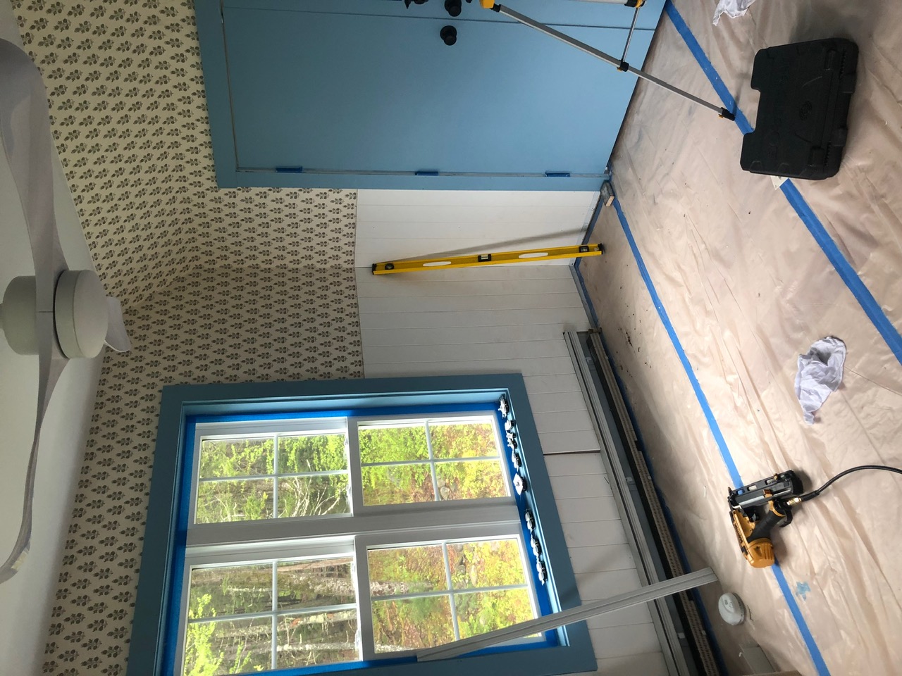 Interior remodel with custom blue window trim, shiplap, and wallpaper