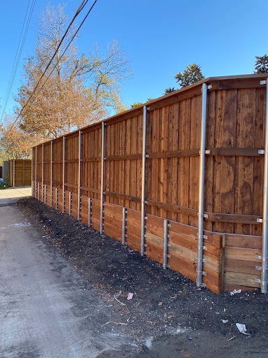 Stained board-on-board cedar fence on galvanized steel posts along an alley in Texarkana, TX