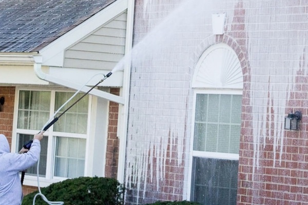 Soft washing a home exterior (hero photo)
