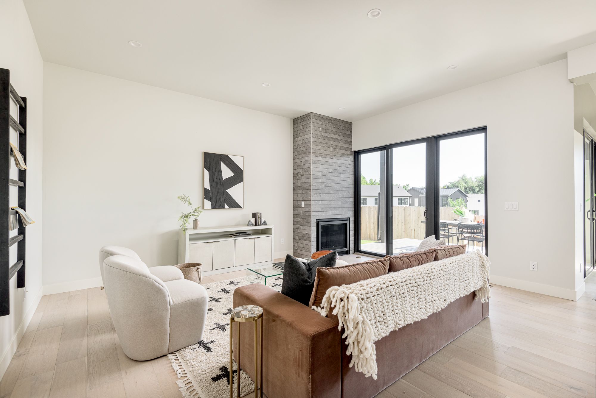 Gray stacked-tile fireplace beside a sofa in the living room