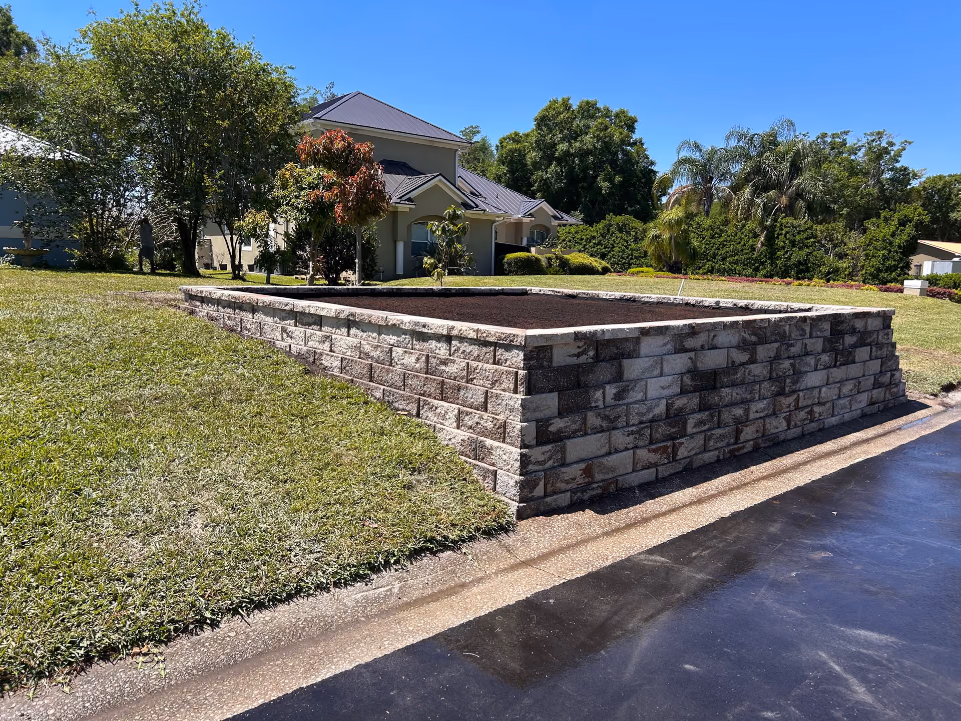 Stone Retaining Wall Garden Bed Built After Storm Damage