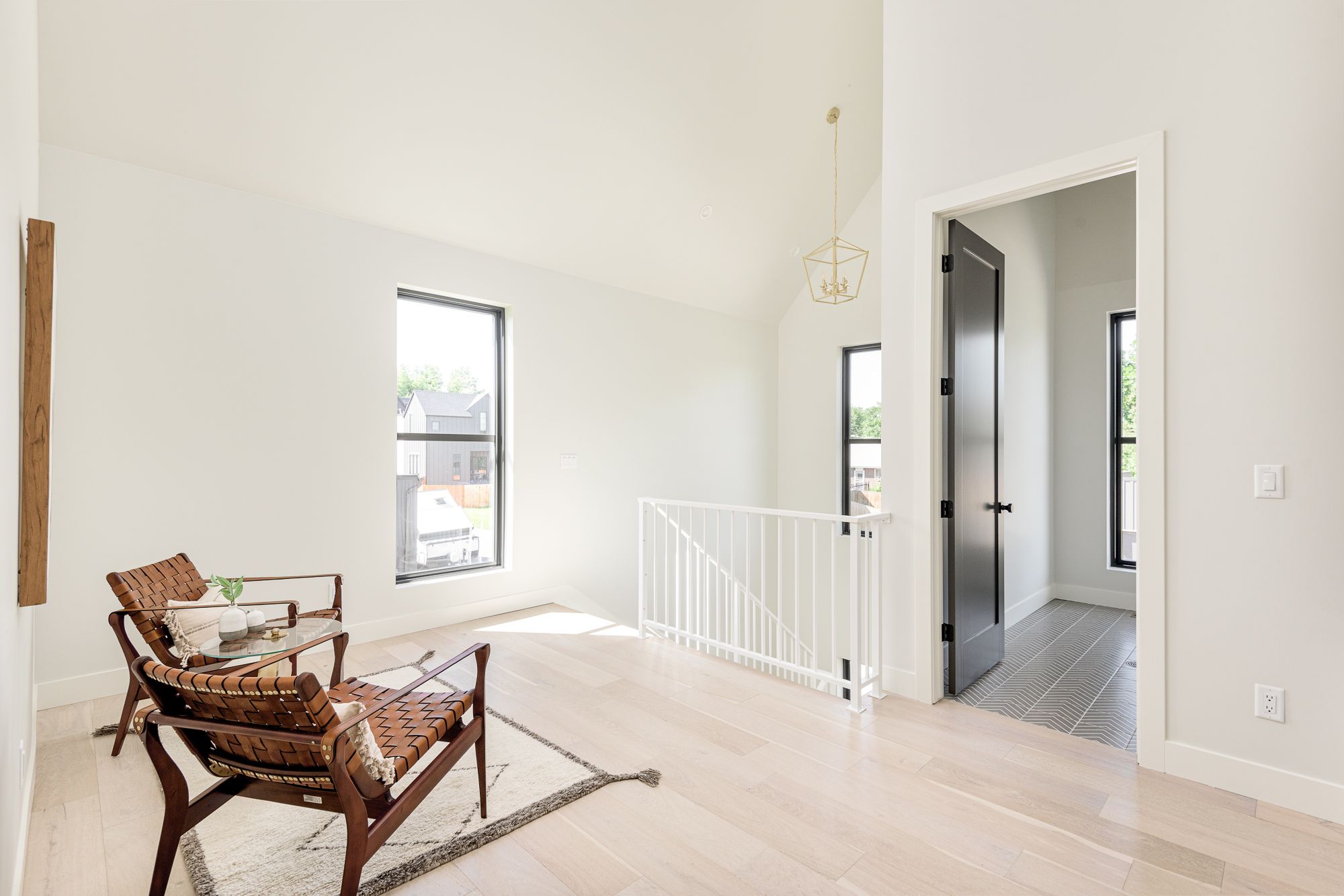 Bedroom nook with a leather chair beside the stair rail