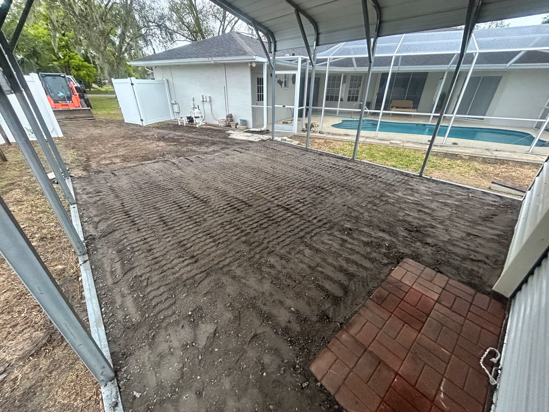 Carport Grading, Asphalt Millings, and Bahia Sod Backyard Fix