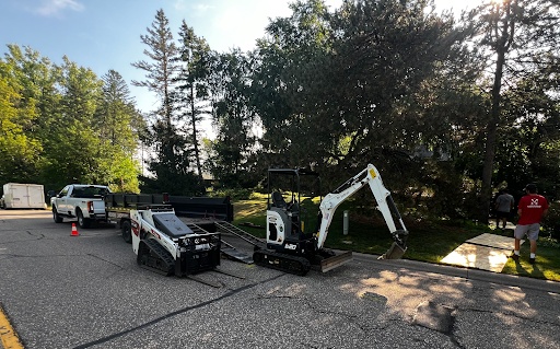 Madisons Landscapes truck and skid loader loading bulk material at the supply yard