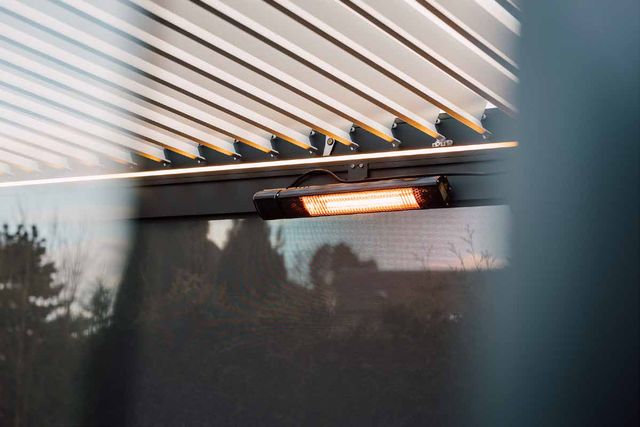 Series 4 pergola interior with warm LED perimeter lighting and zip screens at golden hour