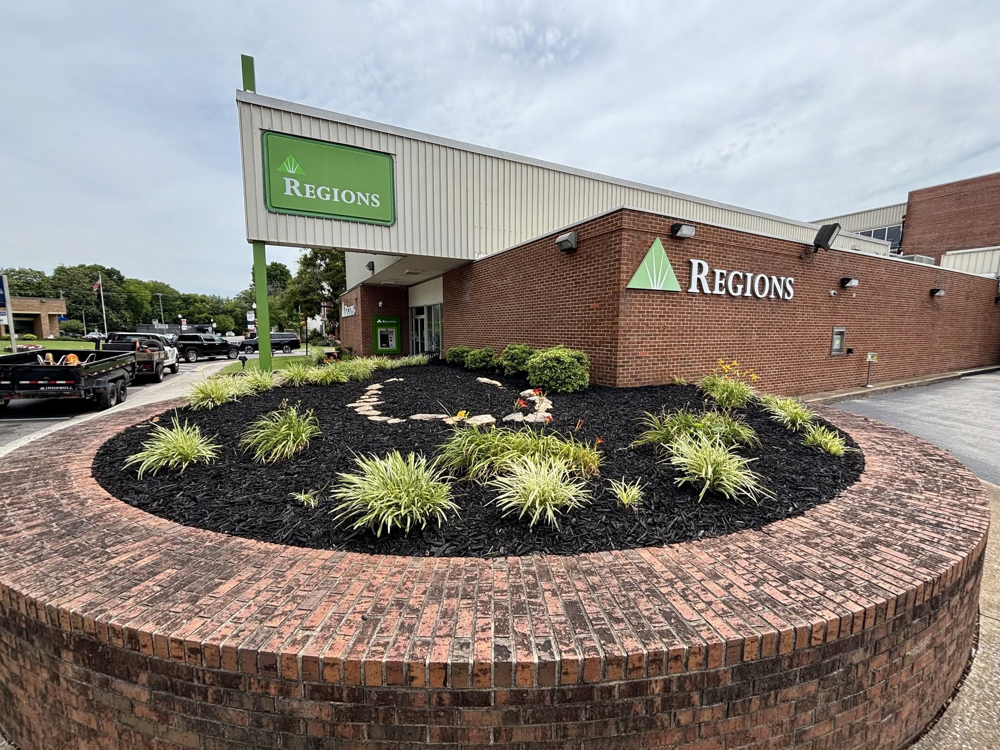 Freshly mulched landscape bed with new plantings at a commercial property