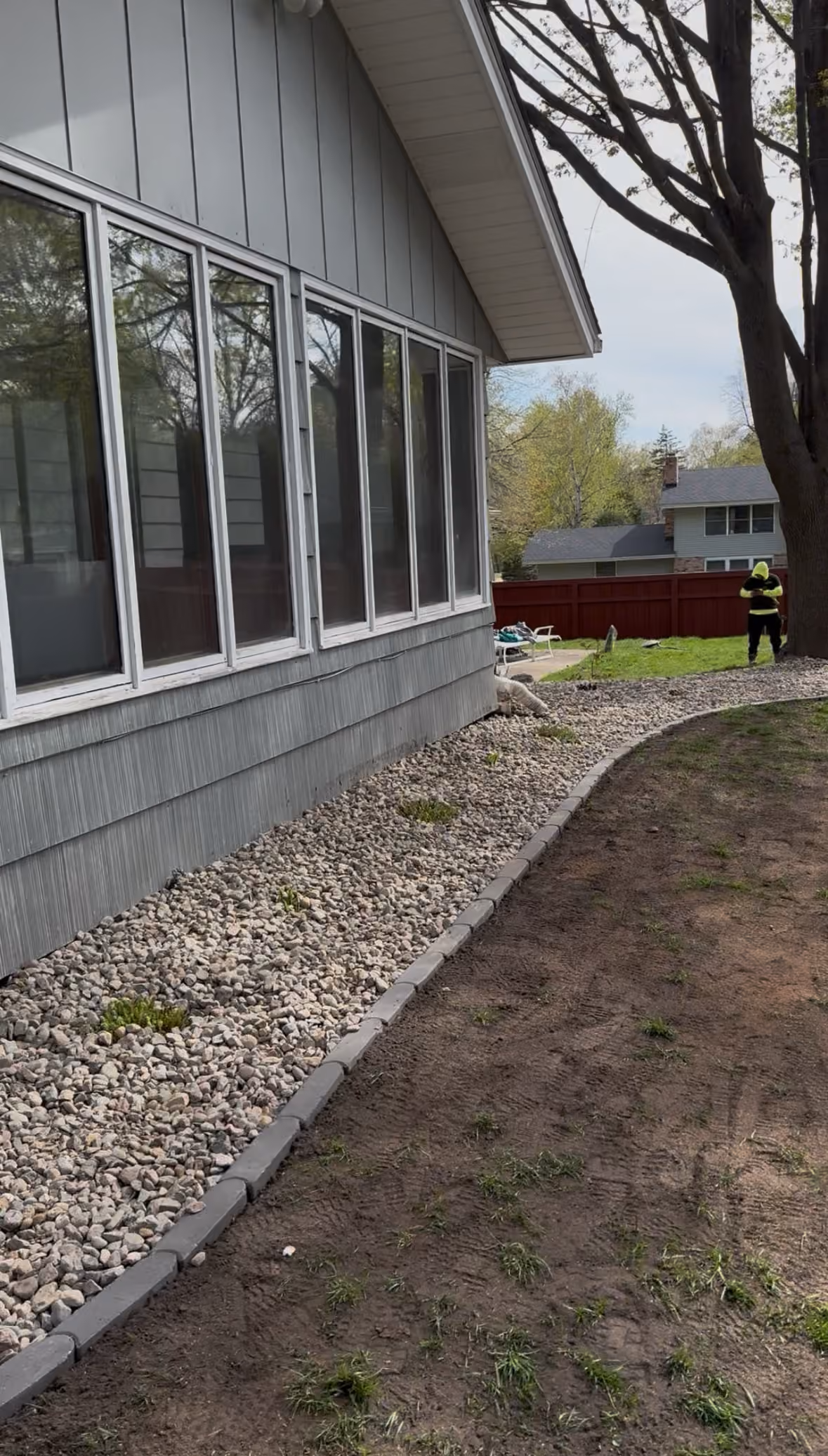 Rock Border and Paver Edging Along a Home Foundation