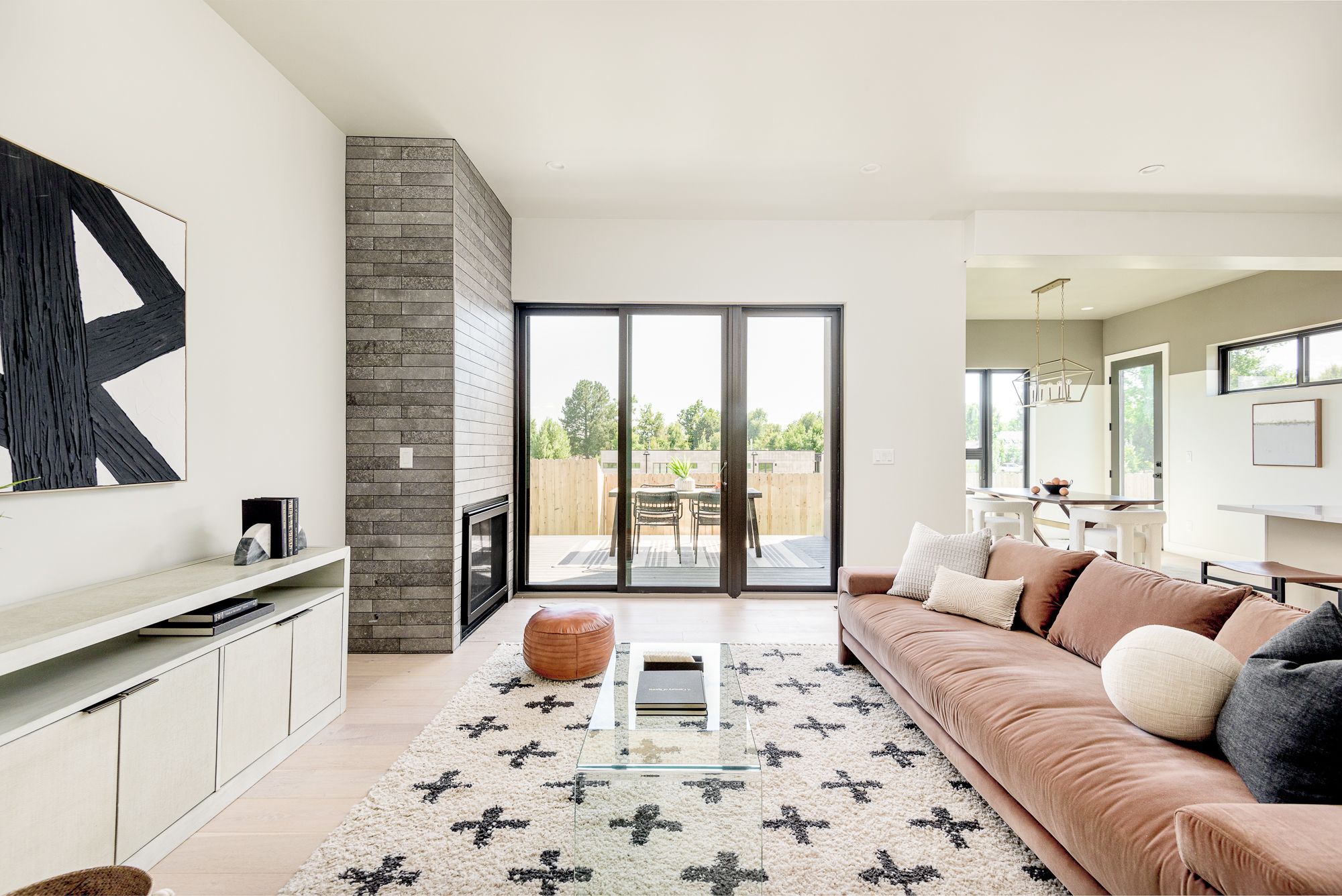 Fireplace straight on, with black sliding doors to the deck beside it