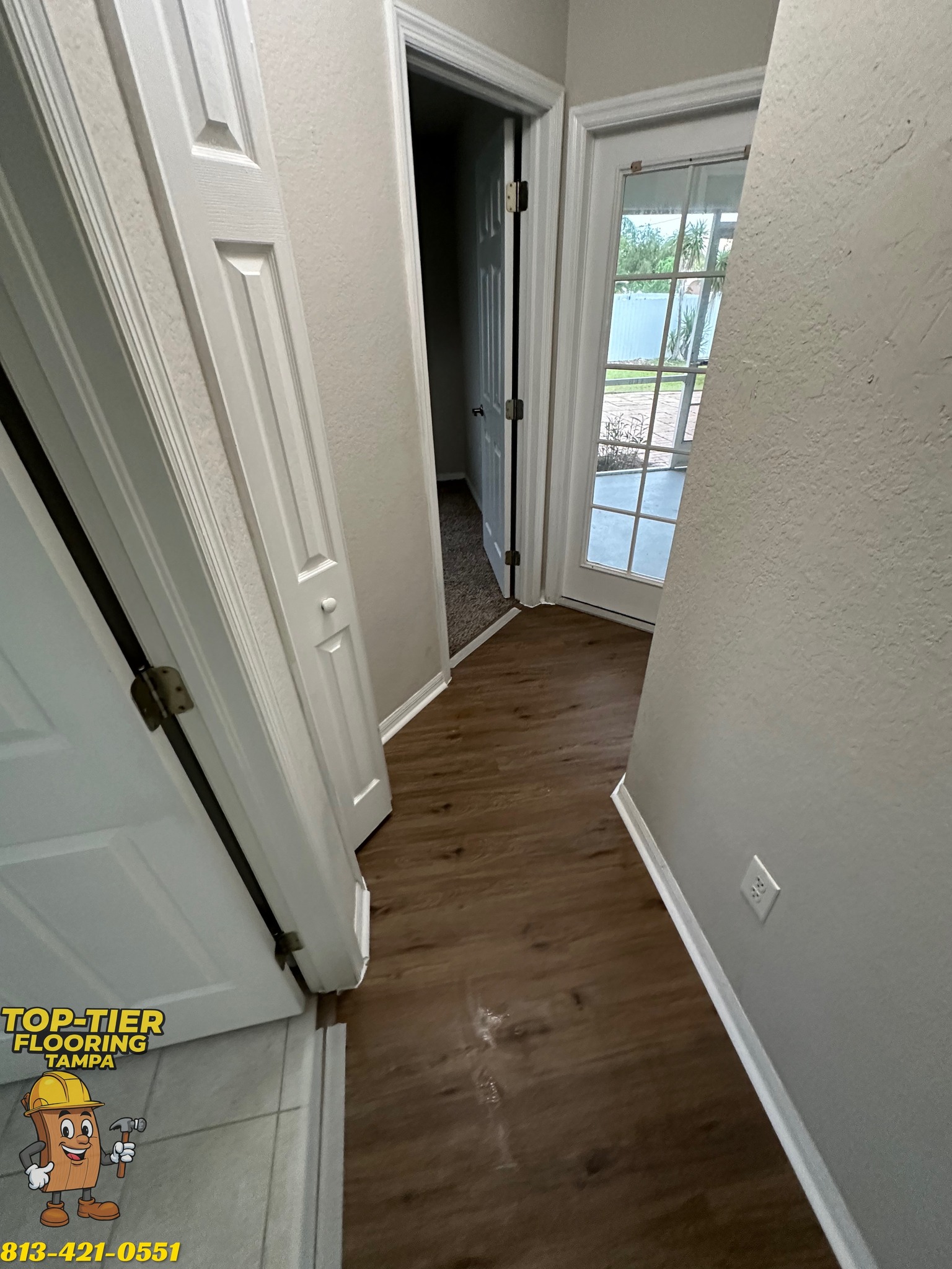 Narrow Tampa, FL hallway with new dark plank flooring