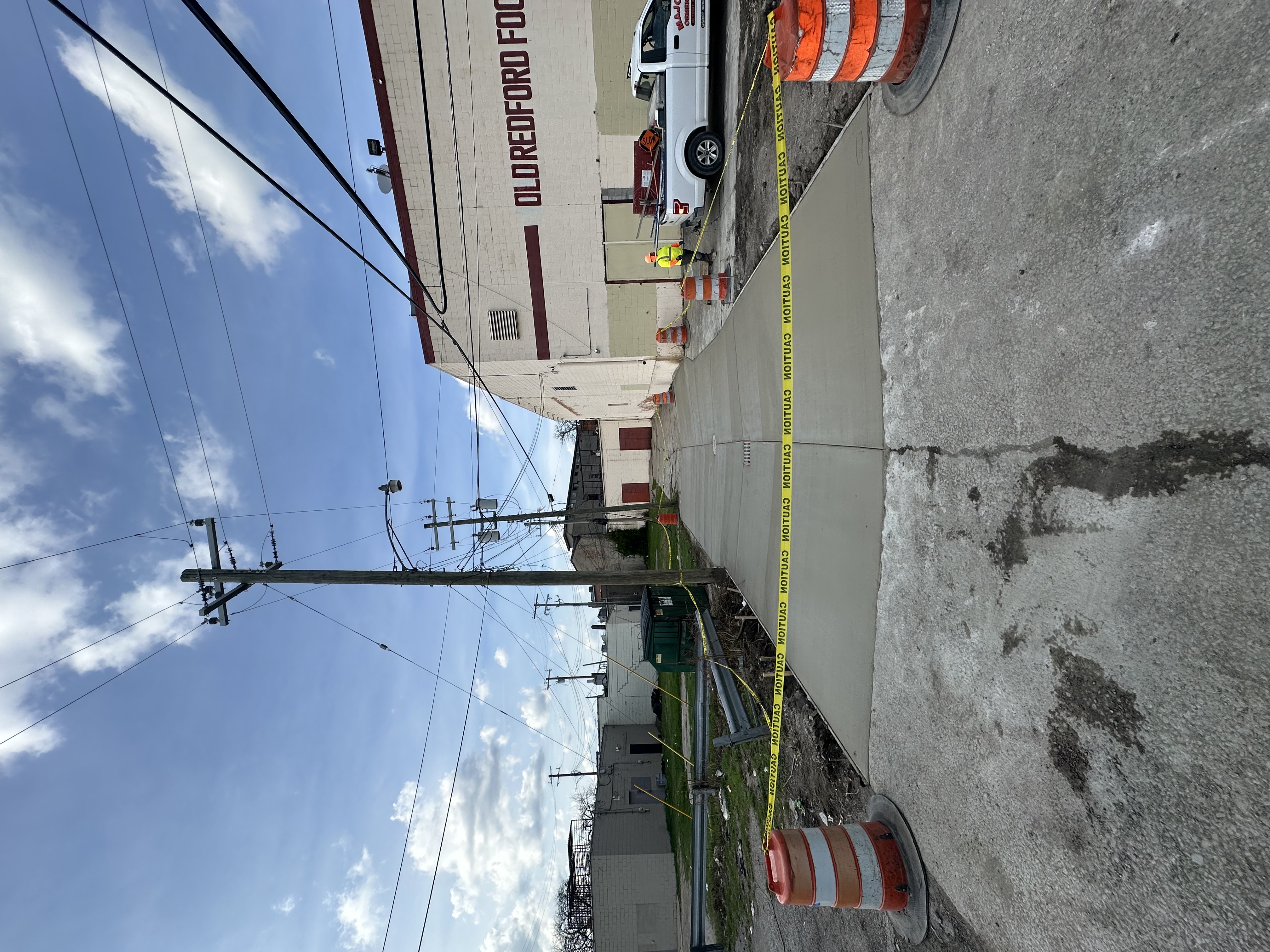Worker raking hot-mix asphalt on a paving job