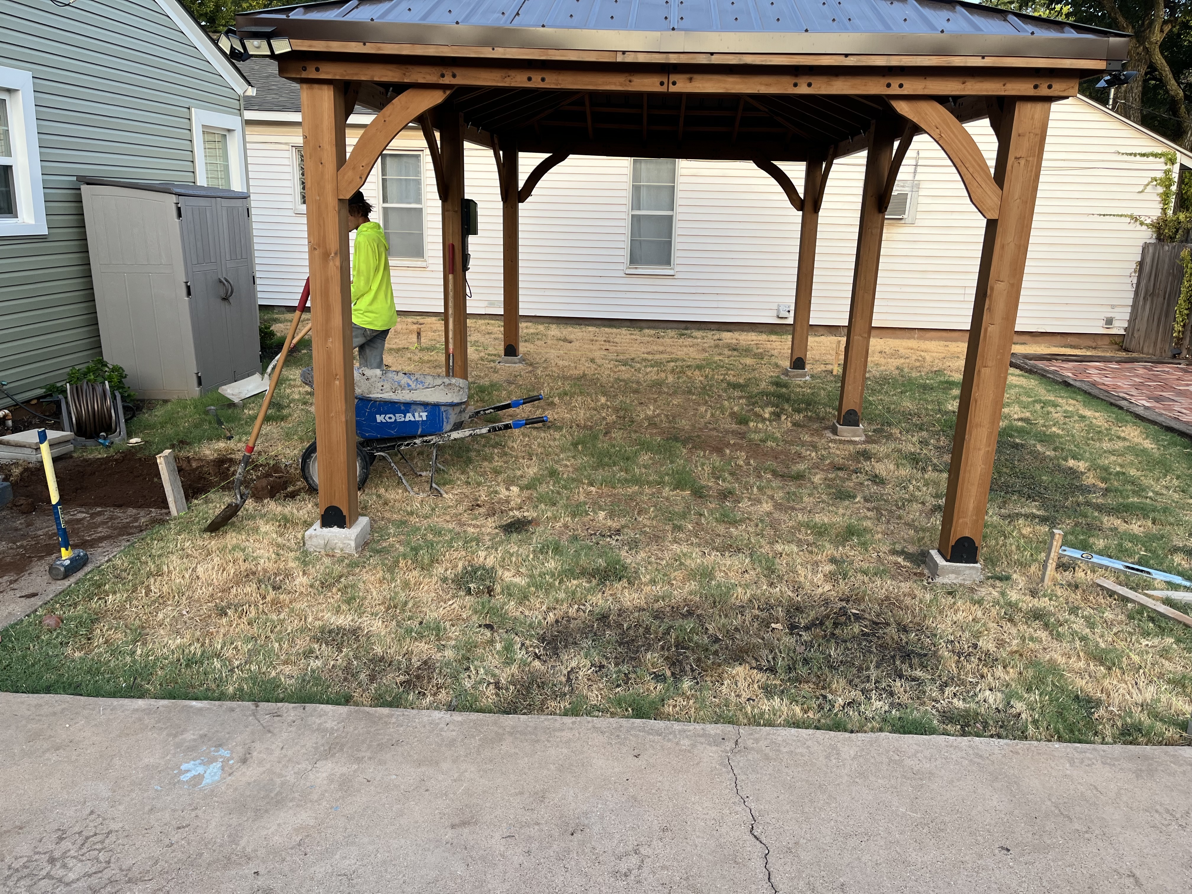 Outdoor pergola concrete patio slab poured beneath wooden pergola by Rock of Ages Concrete LLC