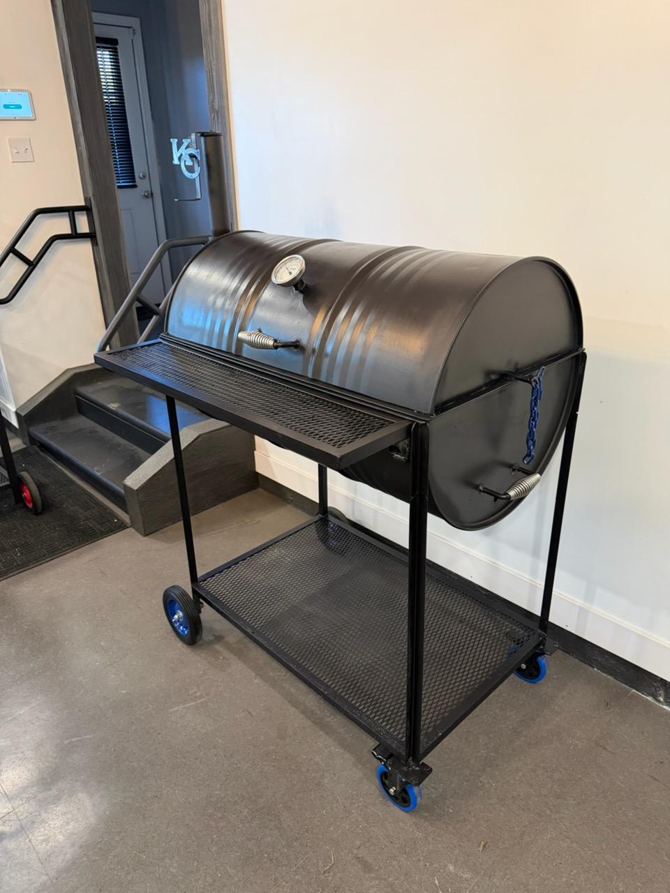 55 gallon drum smoker on a rolling cart, angled view