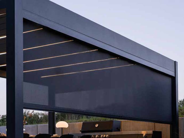 Sliding glass walls enclosing a PERGOLUX pergola
