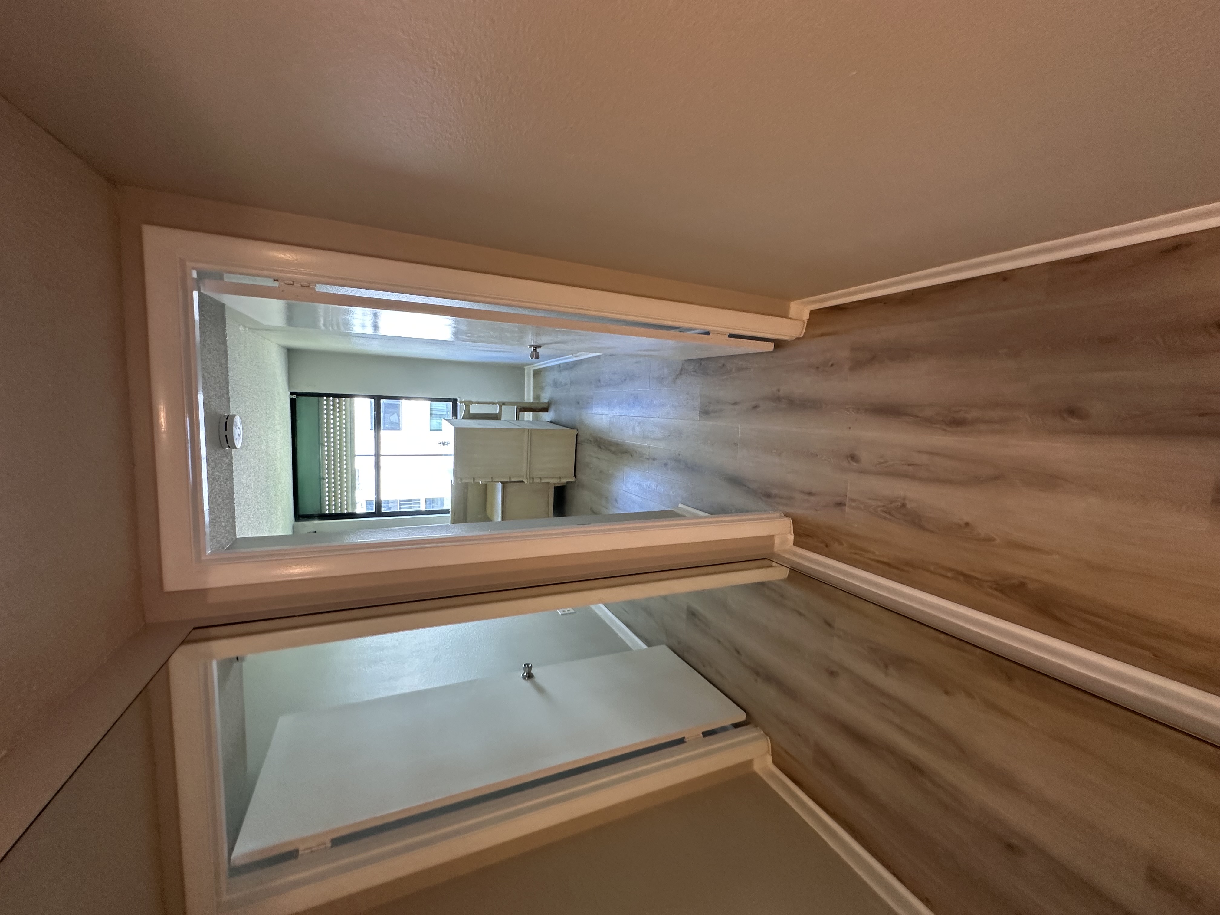 Tampa, FL condo hallway with new medium plank flooring