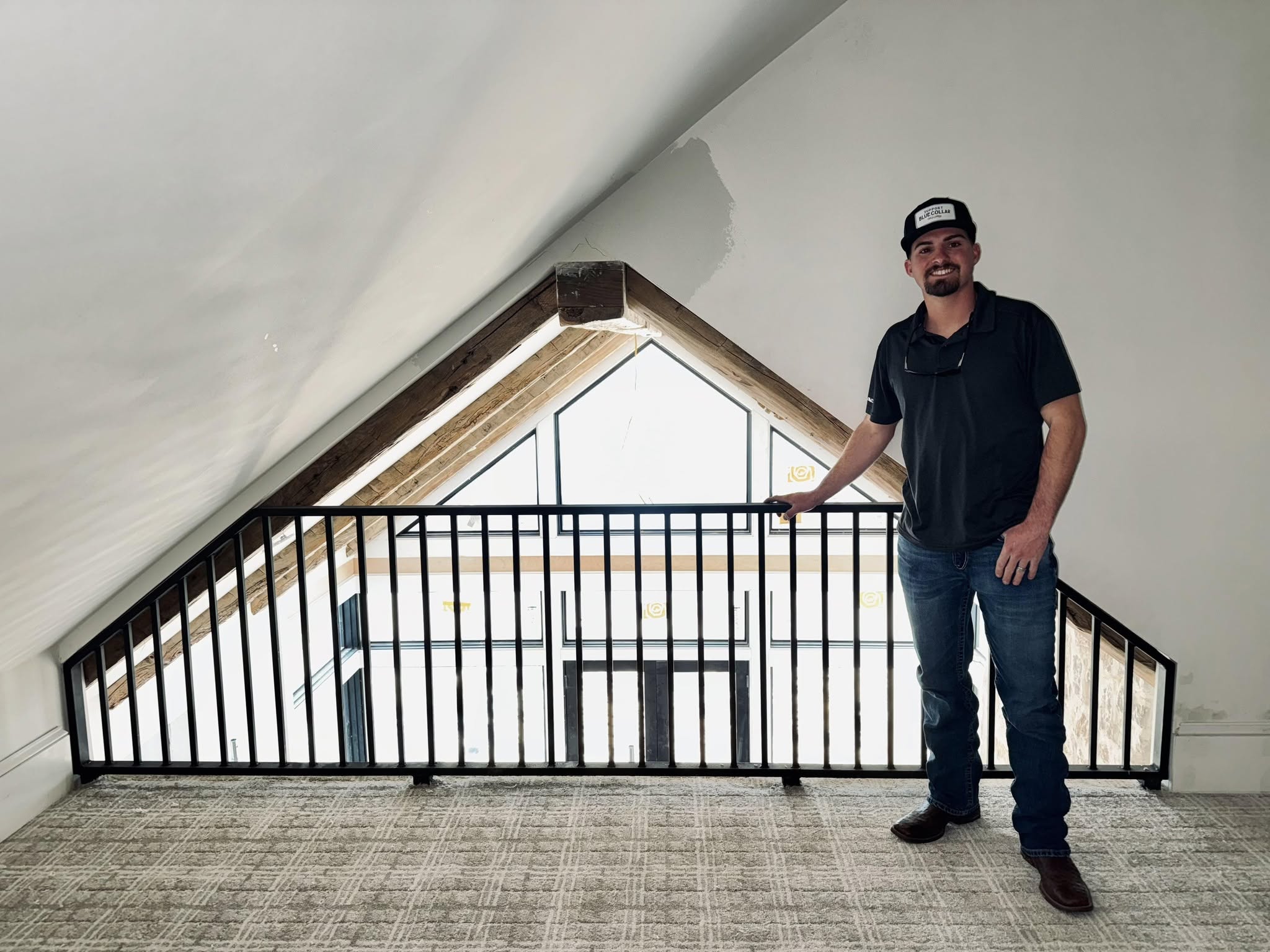 Iron Horse Wood and Metal Works owner standing at a custom black metal railing