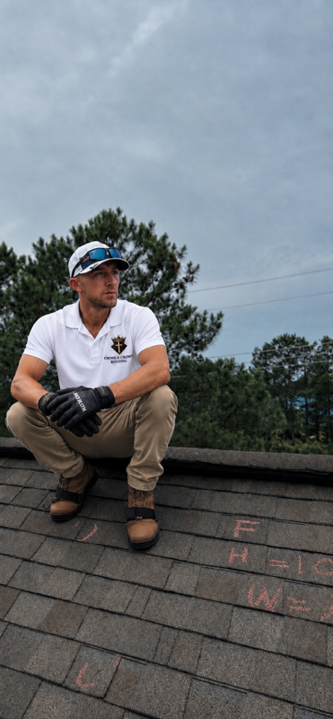 Ralph C. Kennington IV, owner of Cross and Crown Exteriors, on a roof