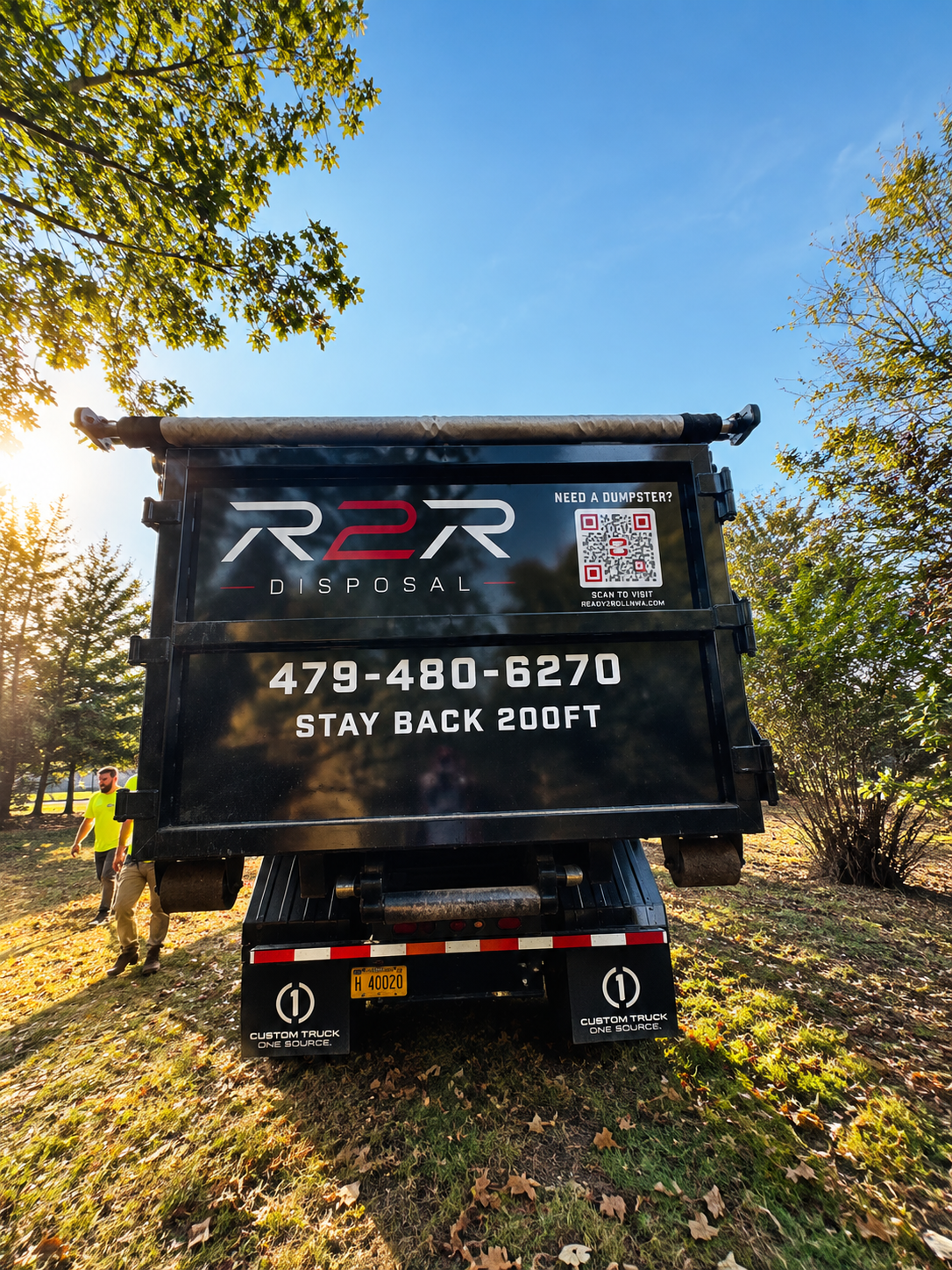 R2R roll-off dumpster set on a driveway at a Northwest Arkansas home