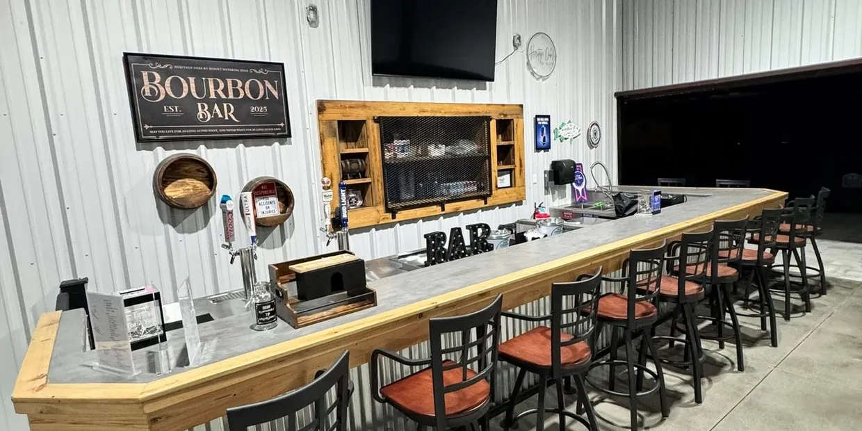 The Heritage Bar's covered counter, taps and barstools at Heritage Oaks RV Resort