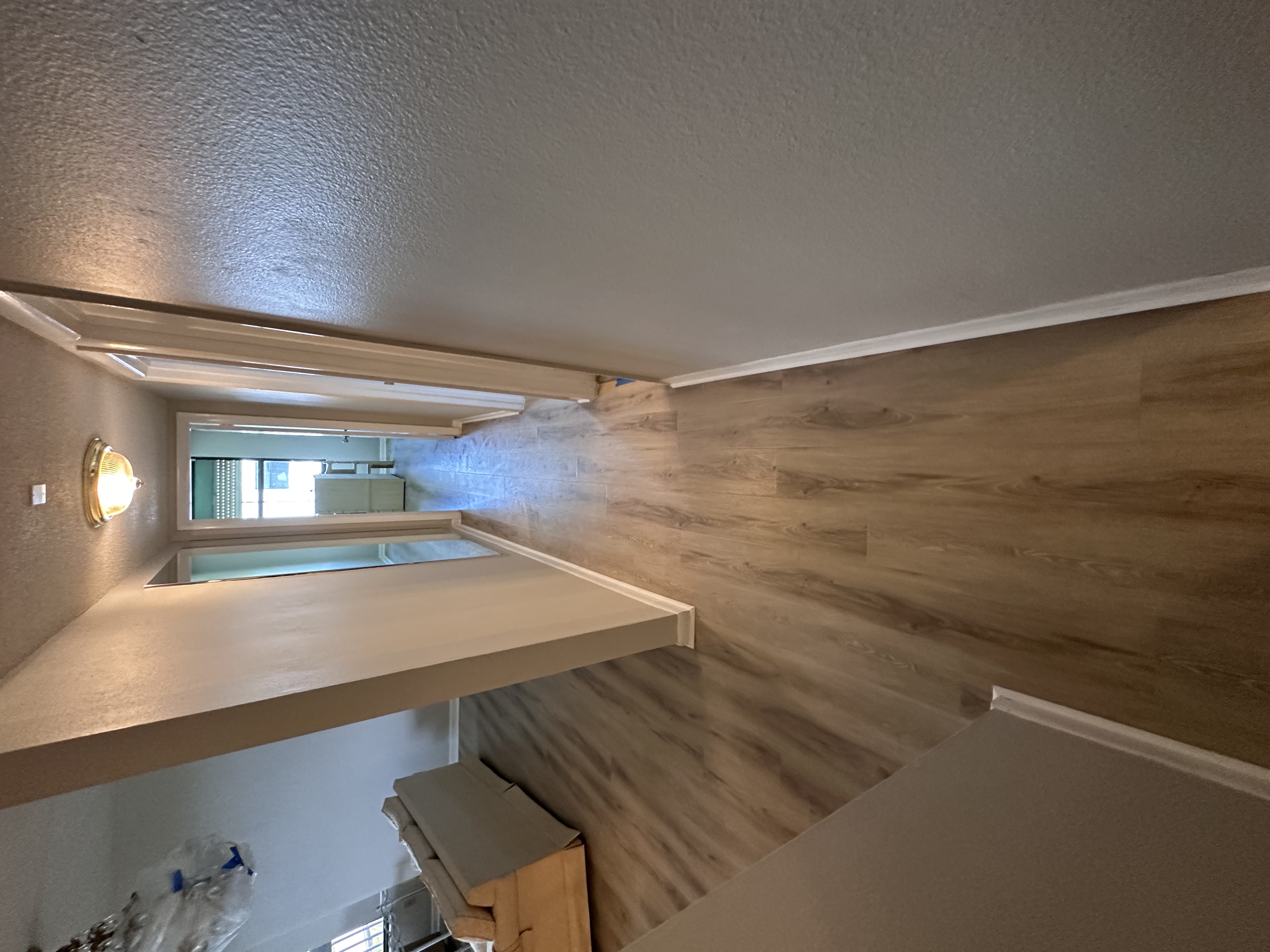 Furnished Tampa, FL hallway with new medium plank flooring