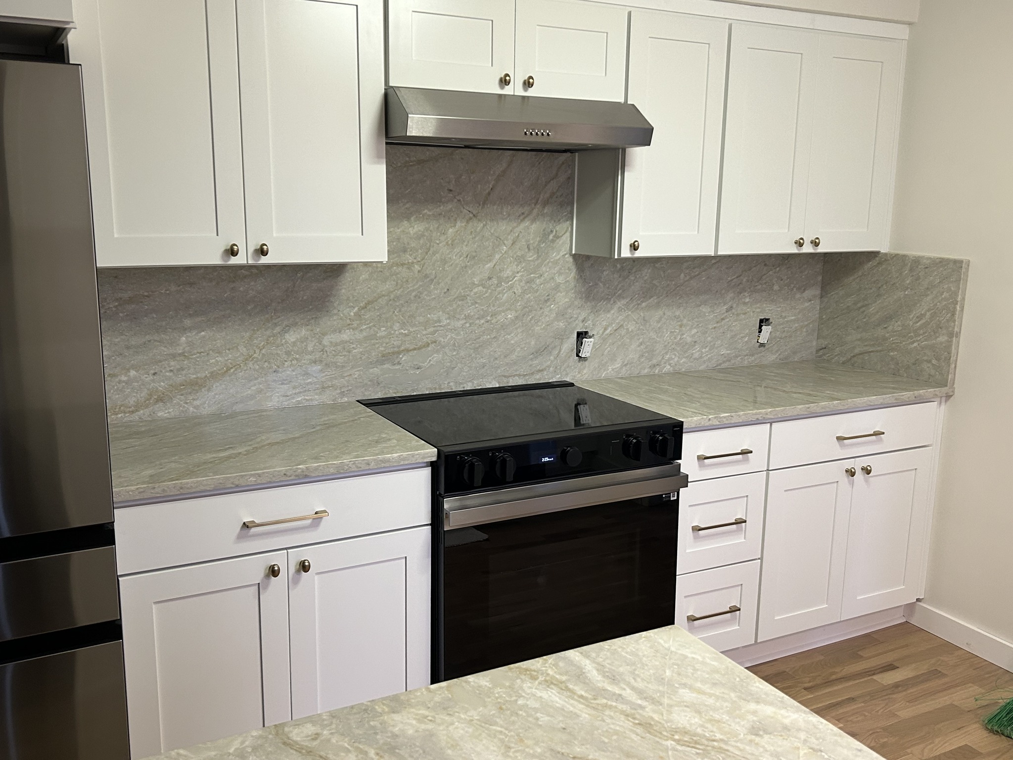 Marble waterfall island with woven pendant lighting — stone countertop installation Springfield Oregon