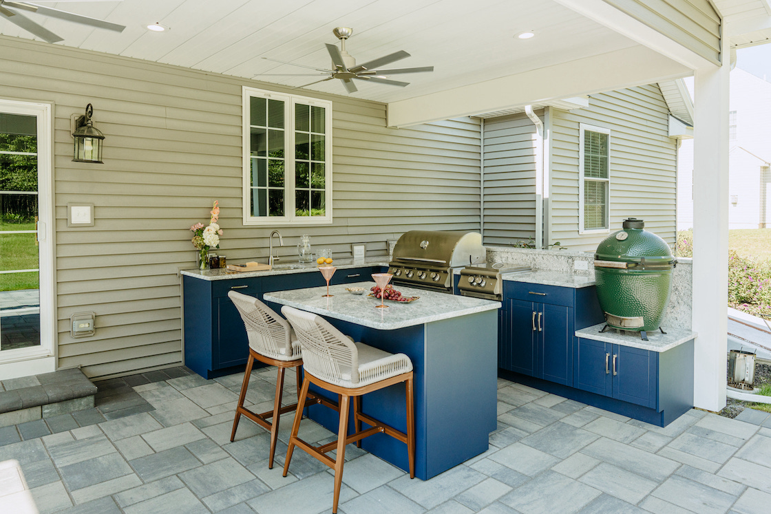 Outdoor kitchen with built-in grill and stone counters