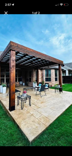 Cedar pergola over a stamped concrete patio with outdoor dining furniture in Texarkana, TX