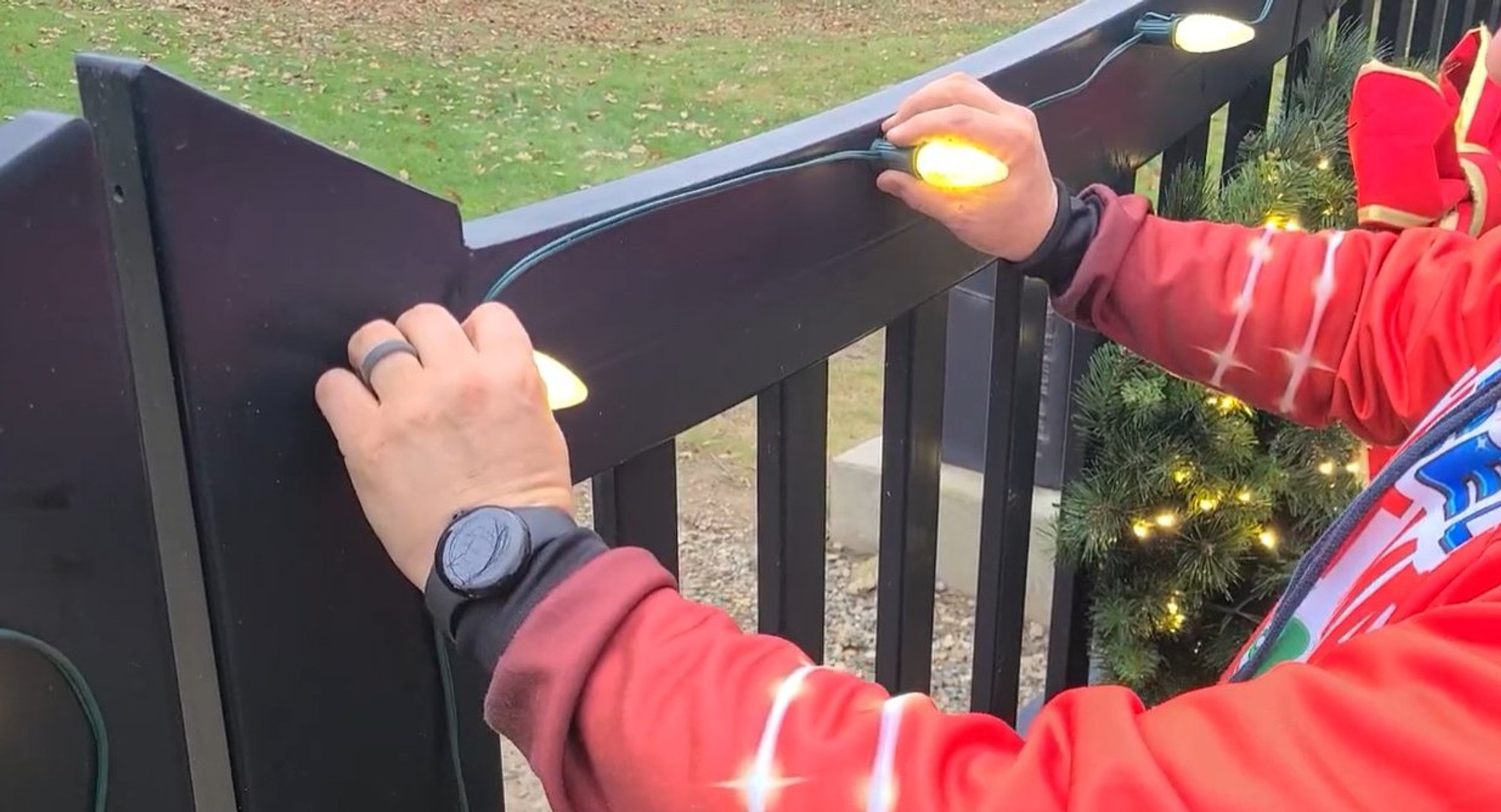 Installer clipping a Christmas light strand in place