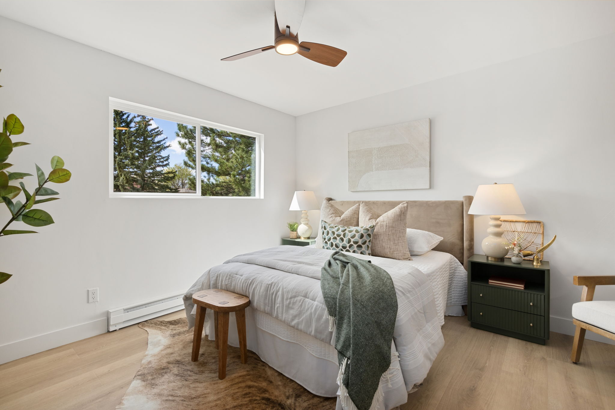 Staged bedroom with a black-framed window