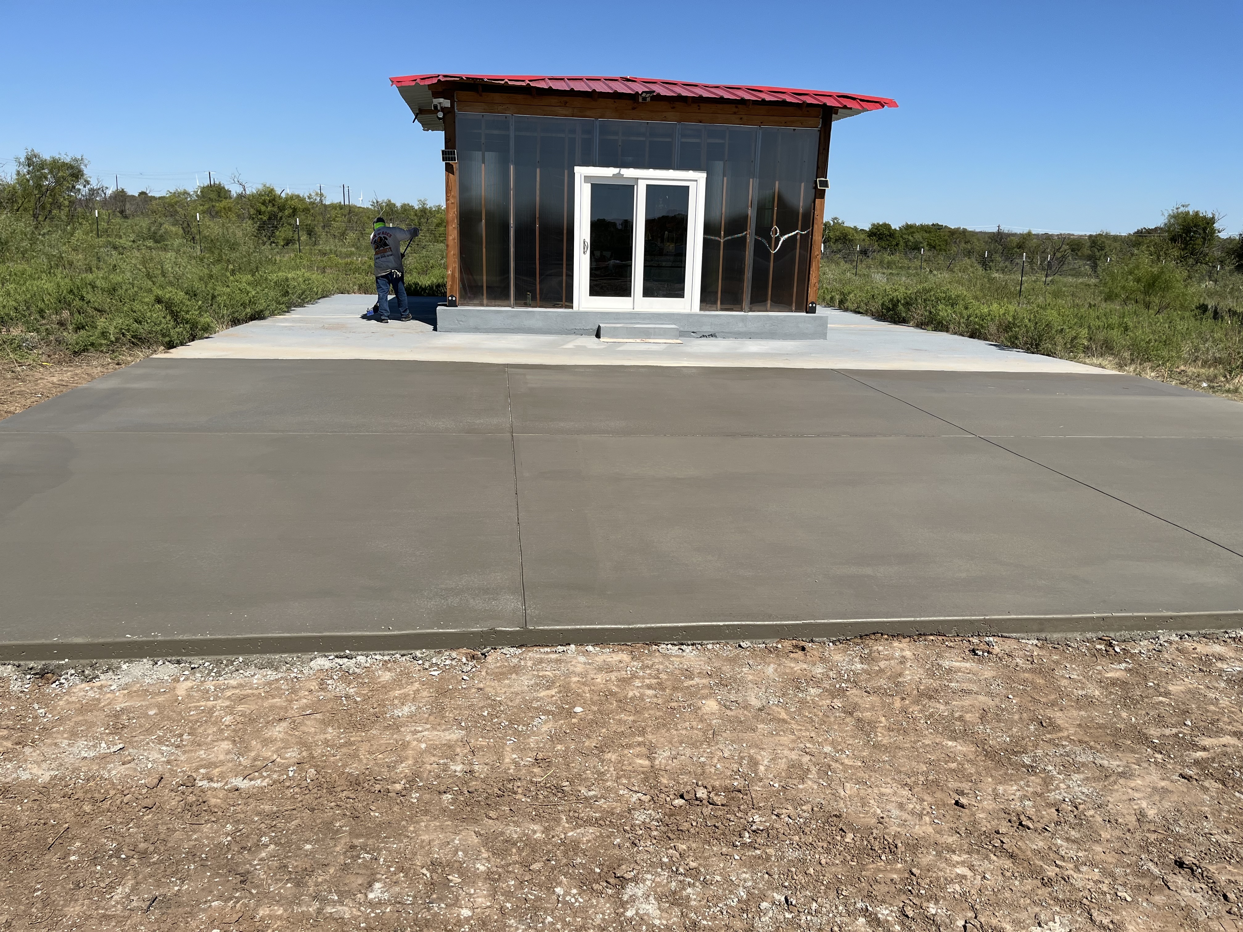 Finished patio concrete slab poured behind a residential home by Rock of Ages Concrete LLC