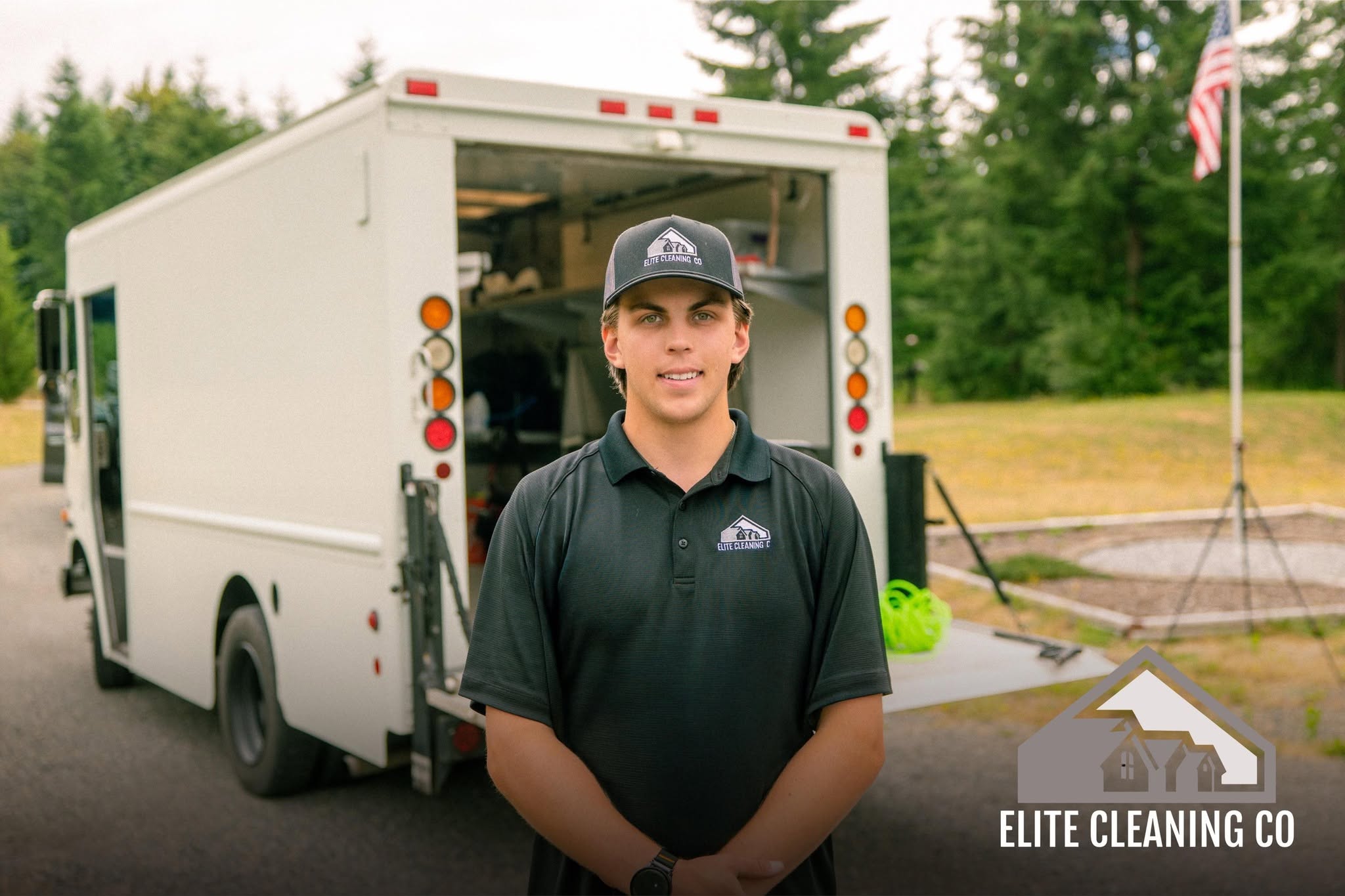Elite Cleaning Co. team member standing in front of the company service truck in Olympia, WA