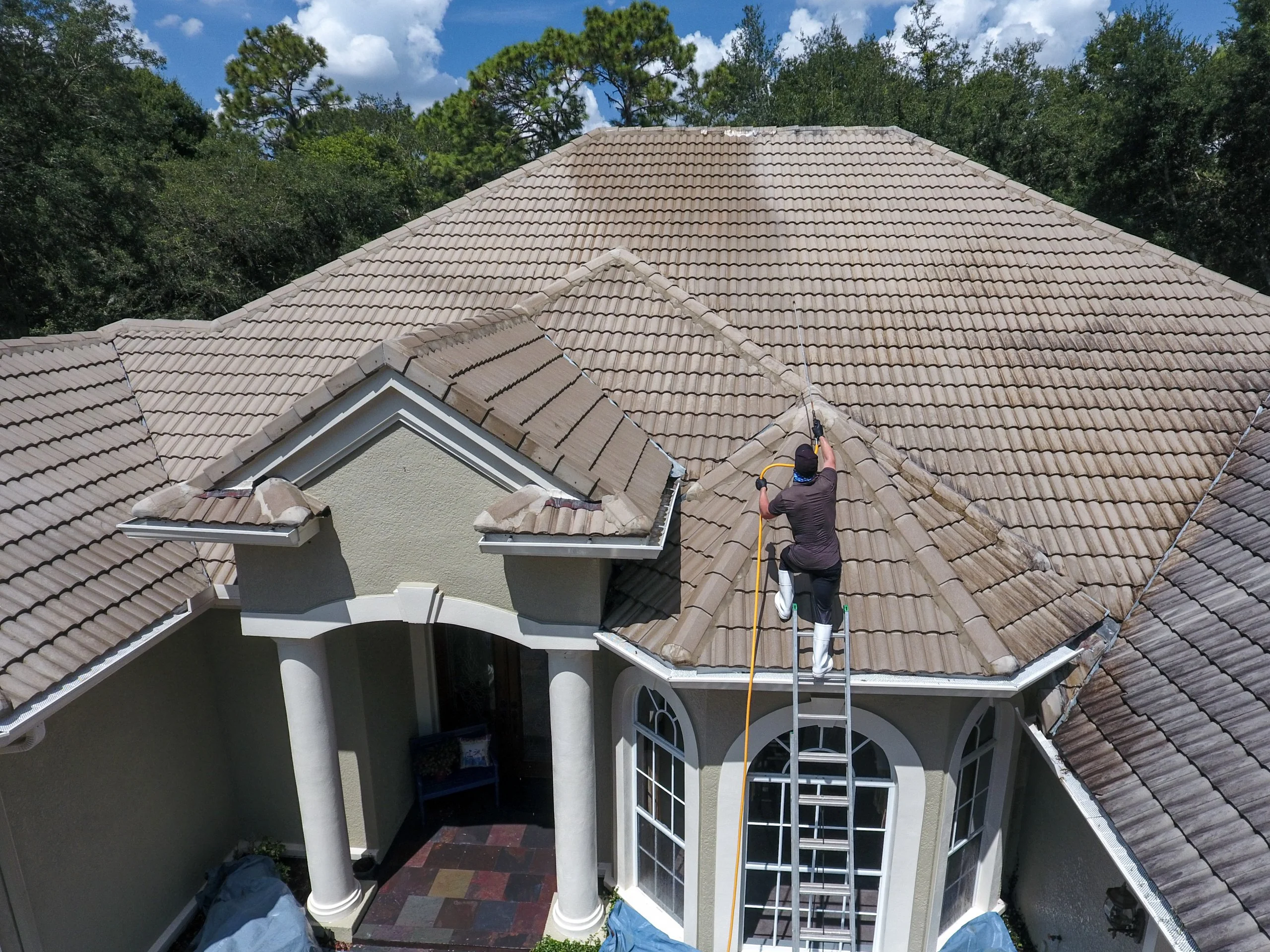 Soft washing a home exterior (hero photo)