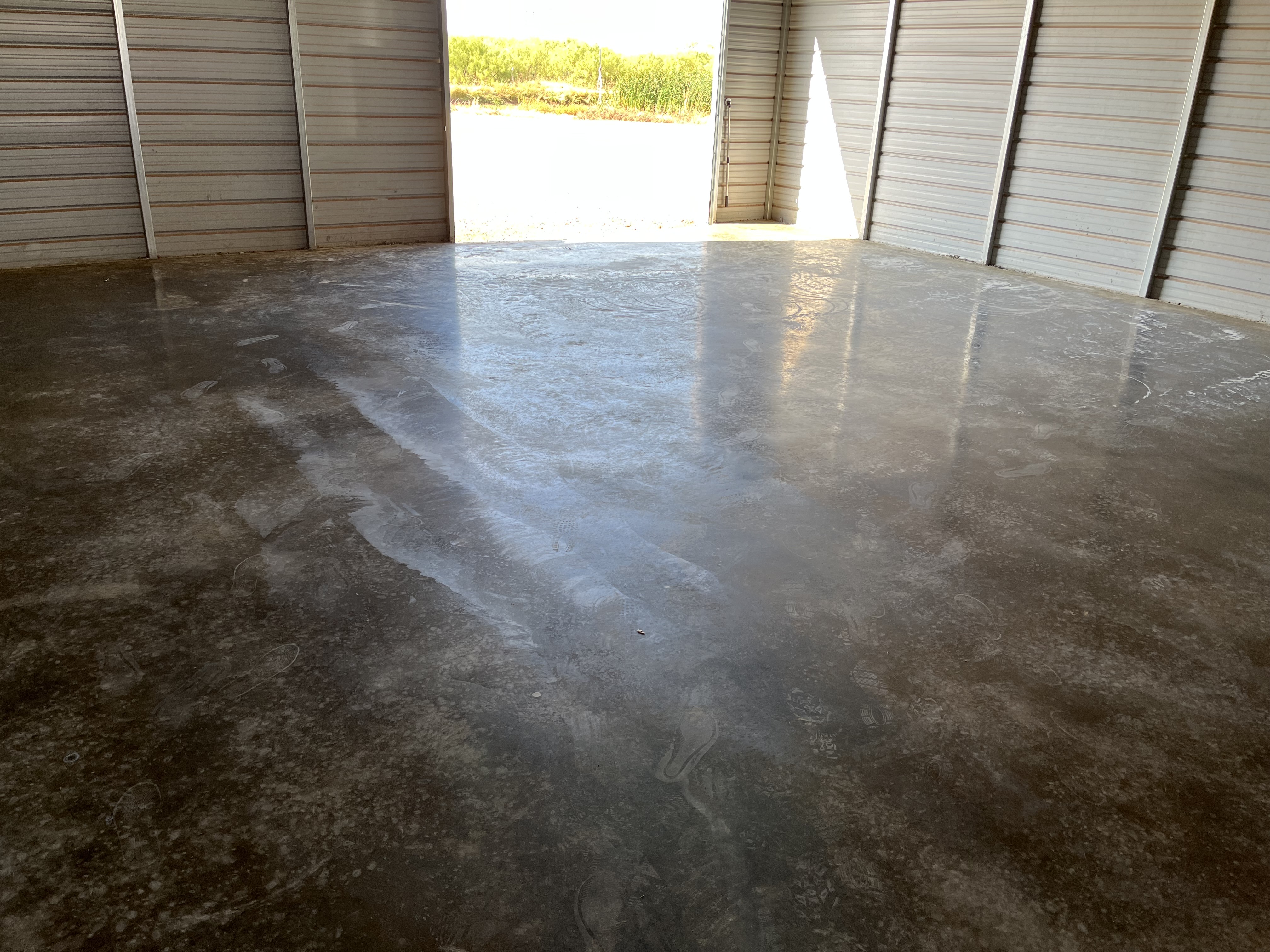 Finished smooth concrete floor slab inside a building by Rock of Ages Concrete LLC