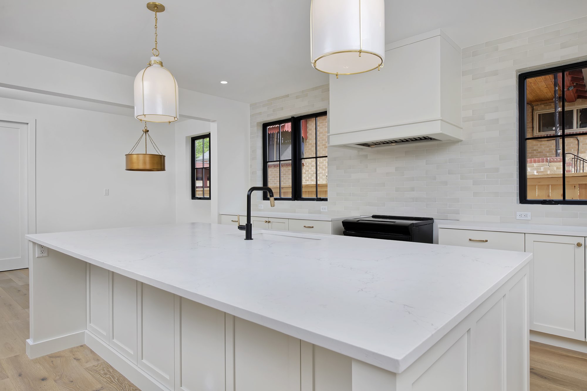 Kitchen bay with floating wood shelves on gray tile, a built-in wine fridge and a paneled refrigerator