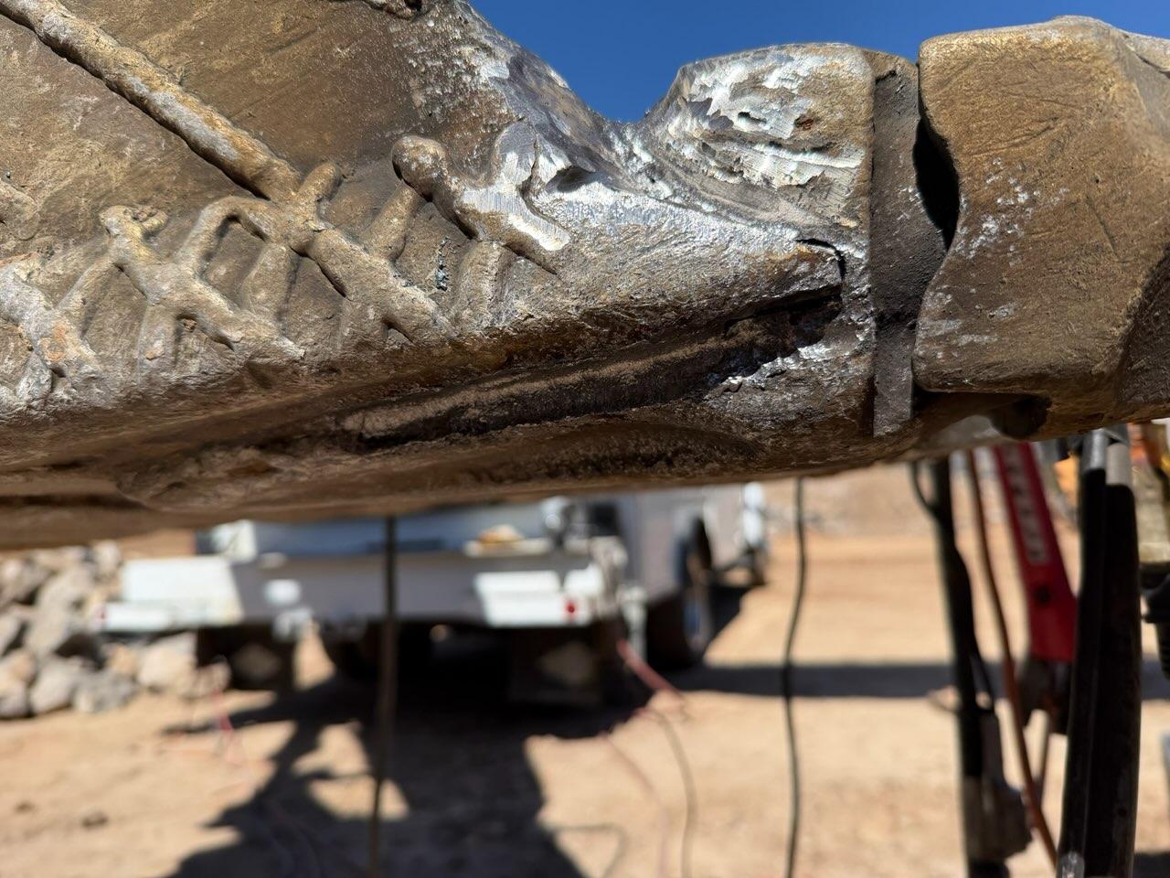 Wide view of the cracked weld on the excavator bucket