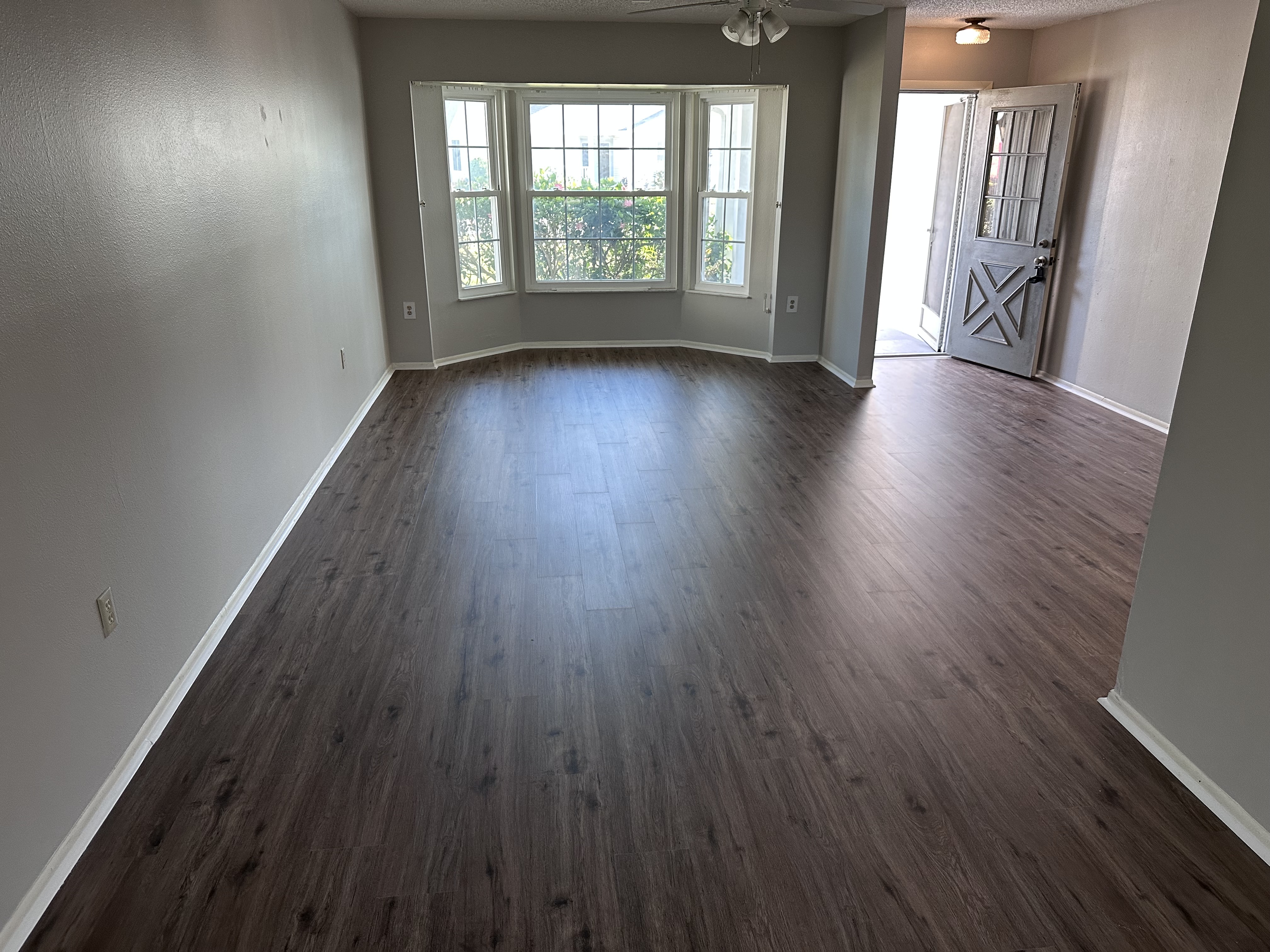Tampa, FL entry room with new dark plank flooring and a bay window