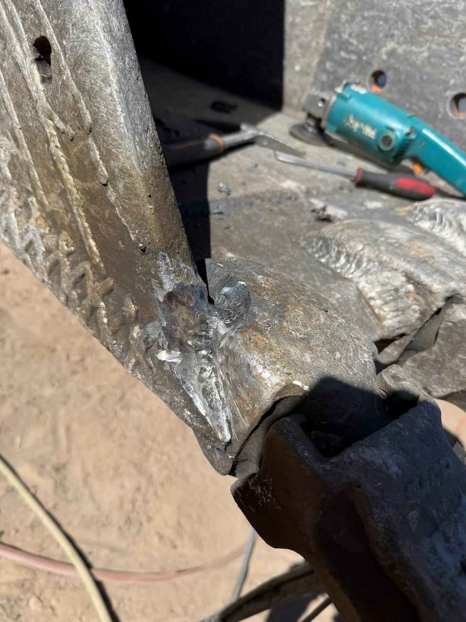 Close-up of the completed weld repair on the bucket