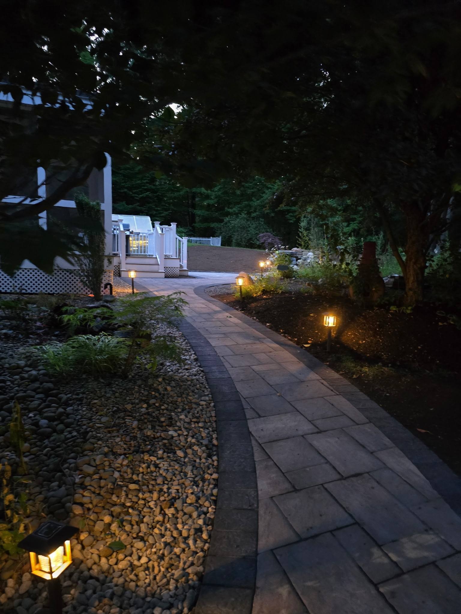 Landscape lighting on a paver walkway at night