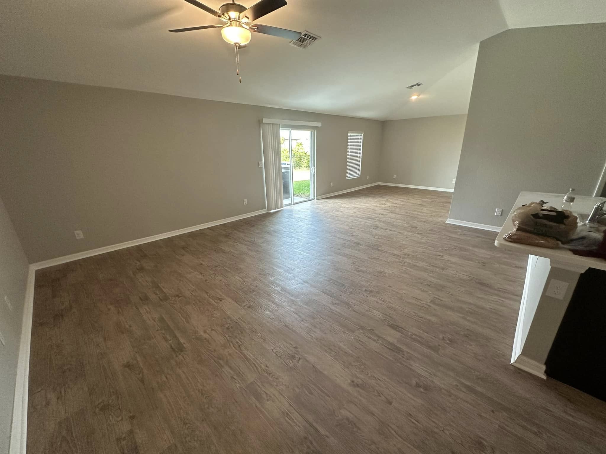 Open great room in Tampa, FL with new medium oak plank flooring