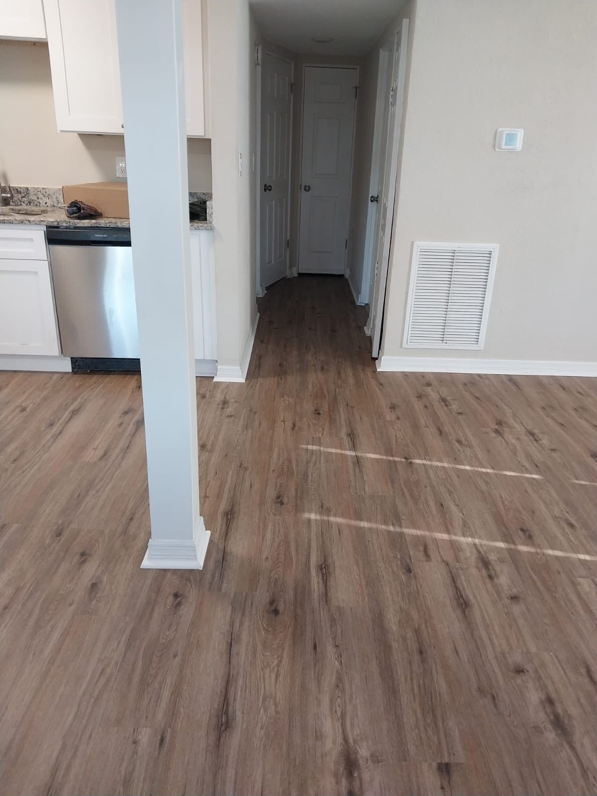 Tampa, FL kitchen and hallway with light oak plank and white baseboards
