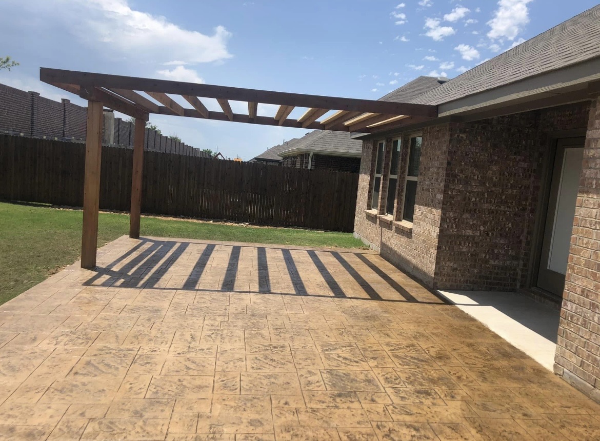 Stamped concrete patio with cedar pergola in Texarkana, TX
