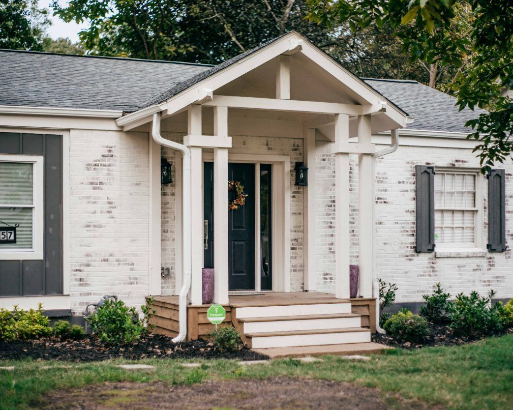 Grey stone facade home with lime wash finish (hero photo)