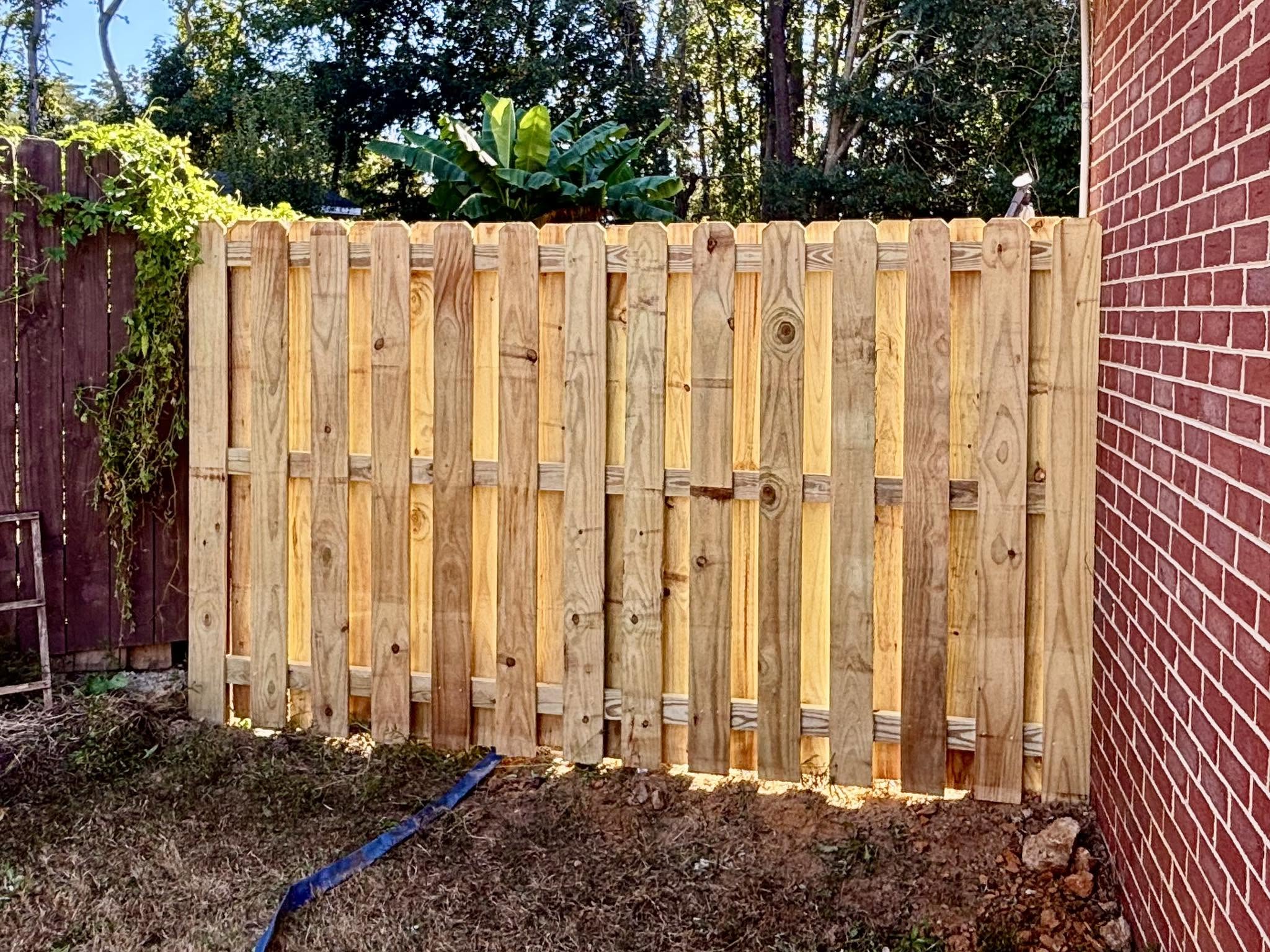 Newly installed wood shadowbox privacy fence