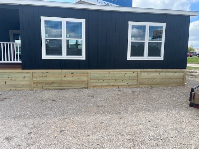 Completed wood skirting installation on a mobile home