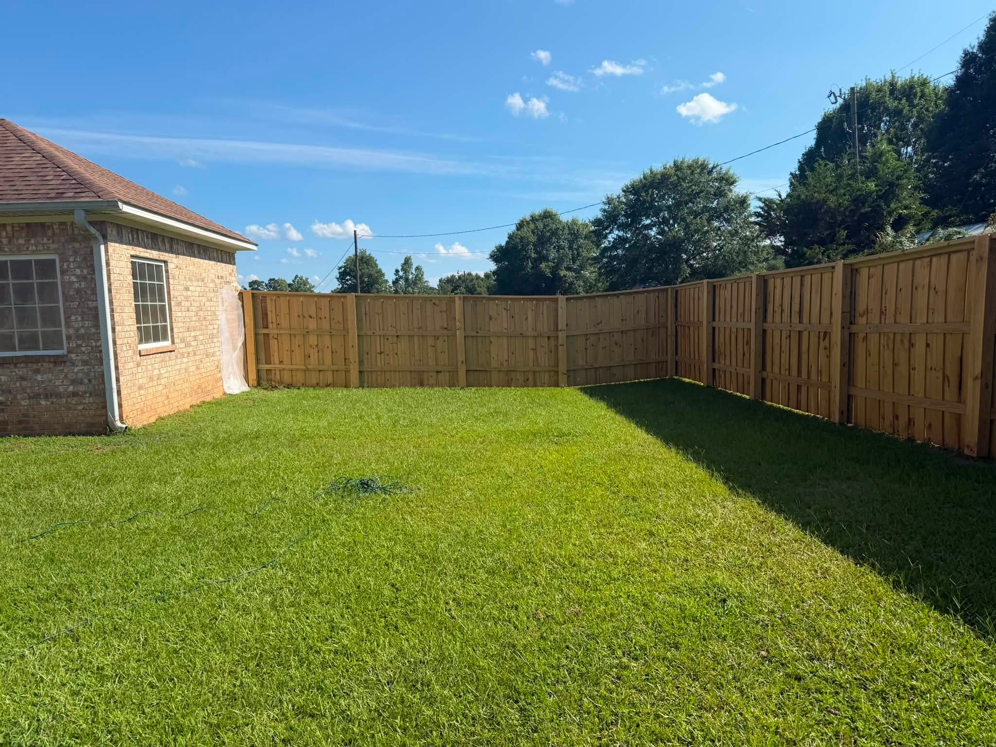 Fresh cedar privacy fence backyard installation in Texarkana, TX