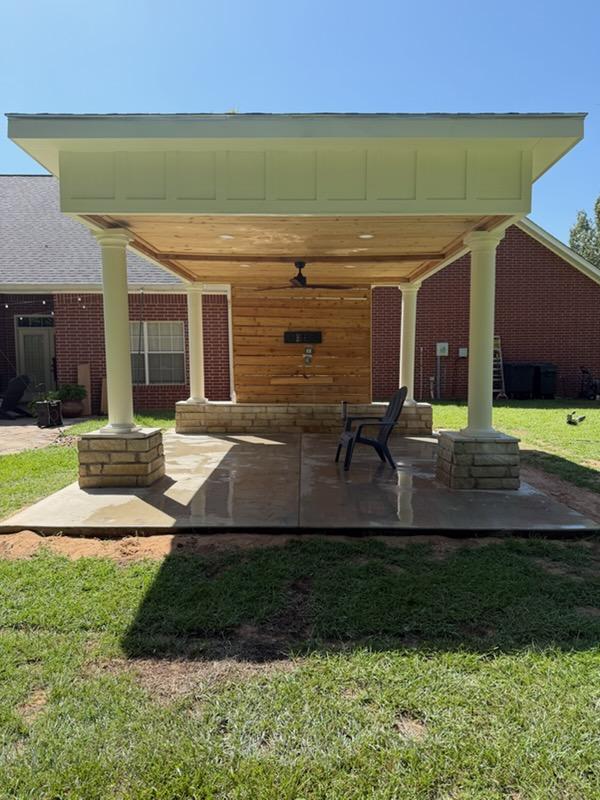 Covered patio structure with stone-base columns in Texarkana, TX